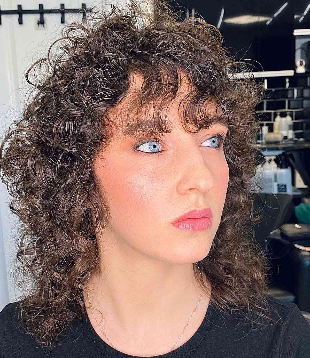 Shoulder-Length '80s Curly Mullet with Wispy Bangs