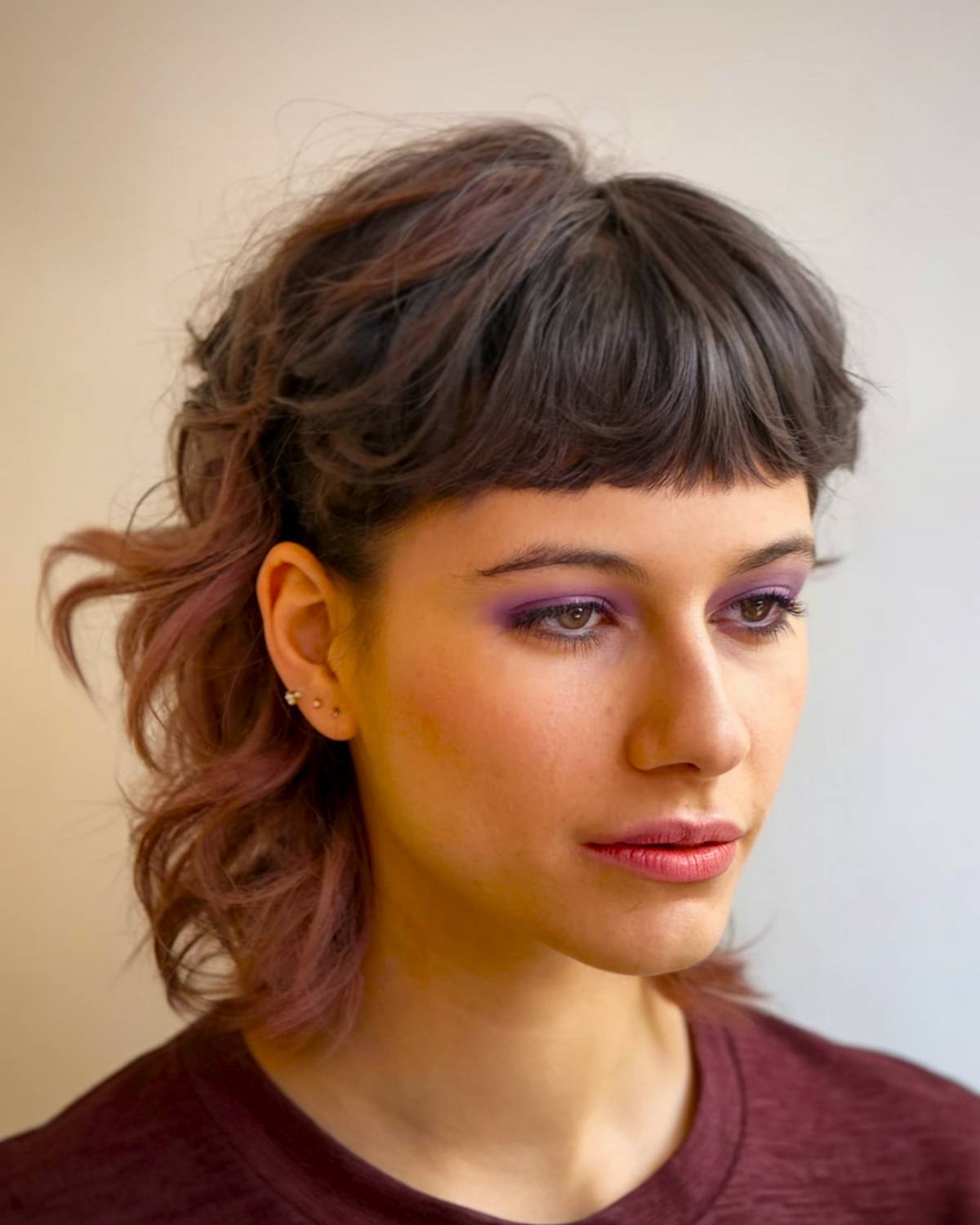 90s-inspired mullet with flipped ends and soft layers for a playful, retro vibe