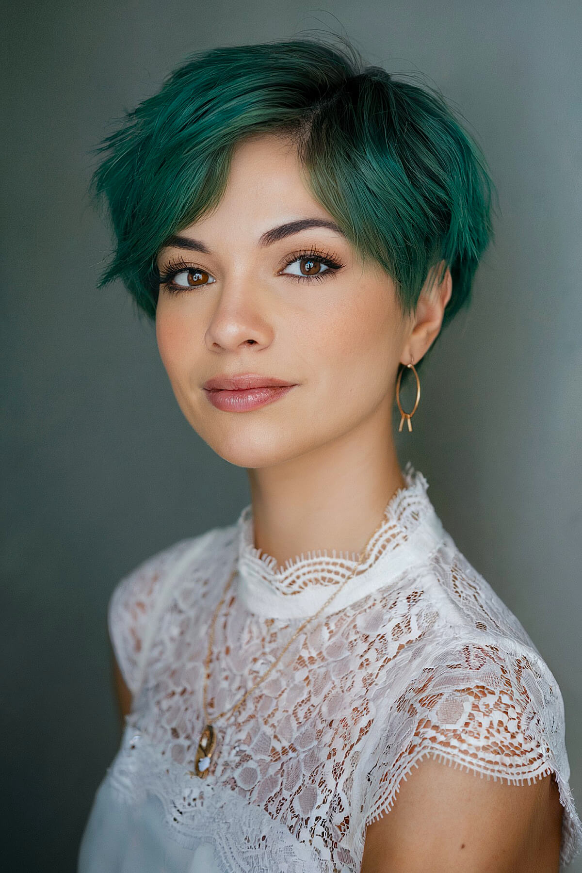 Christmas hair color idea with emerald green pixie cut