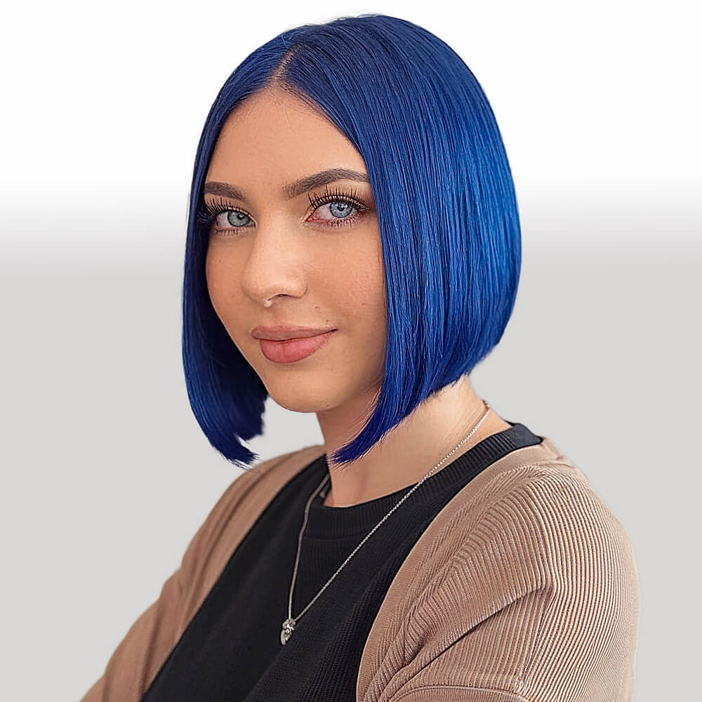 Woman with a vivid cobalt blue A-line bob haircut framing her oval face