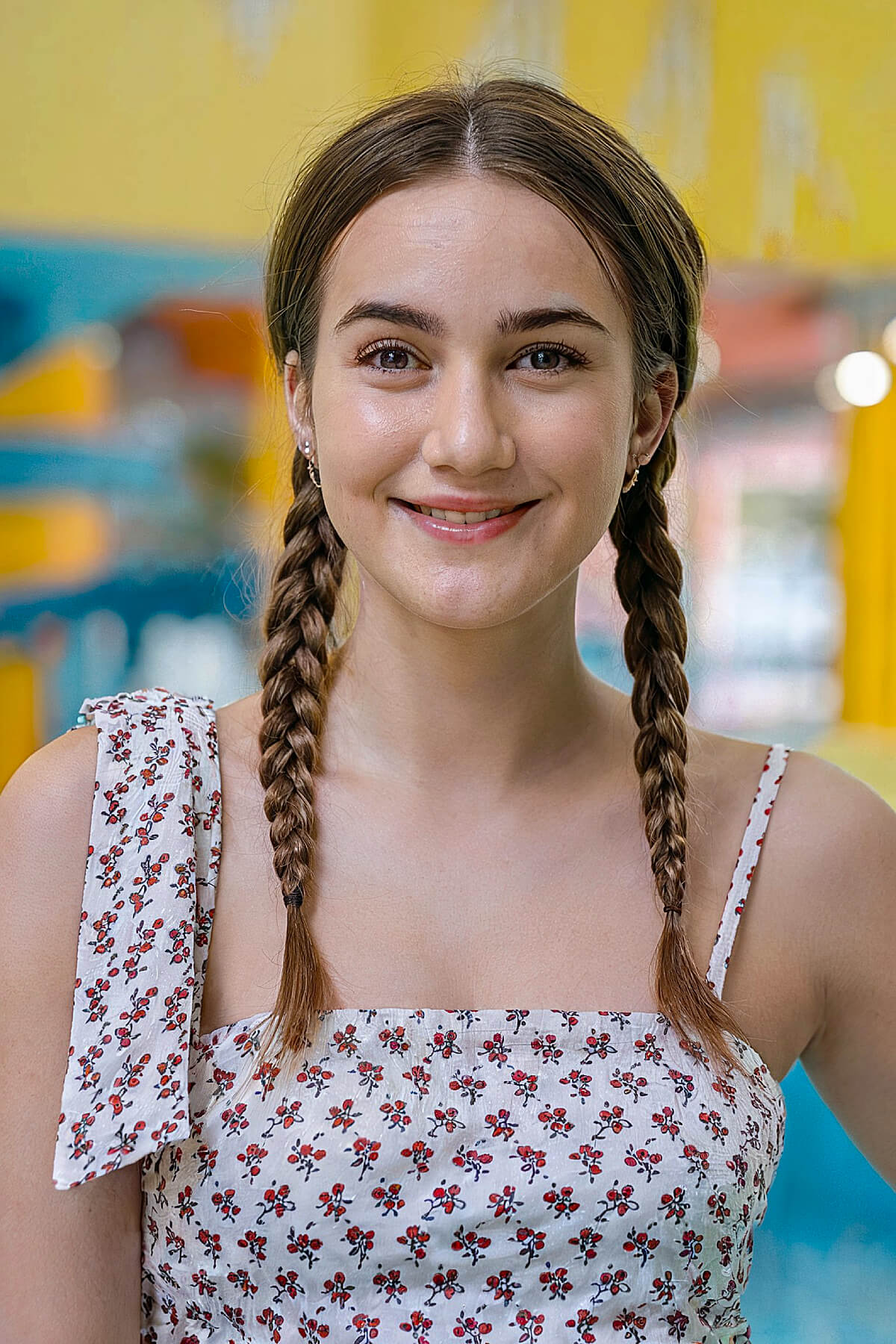 A woman with fun summer pigtails, ideal for medium-length hair and easy to manage for a day at the waterpark