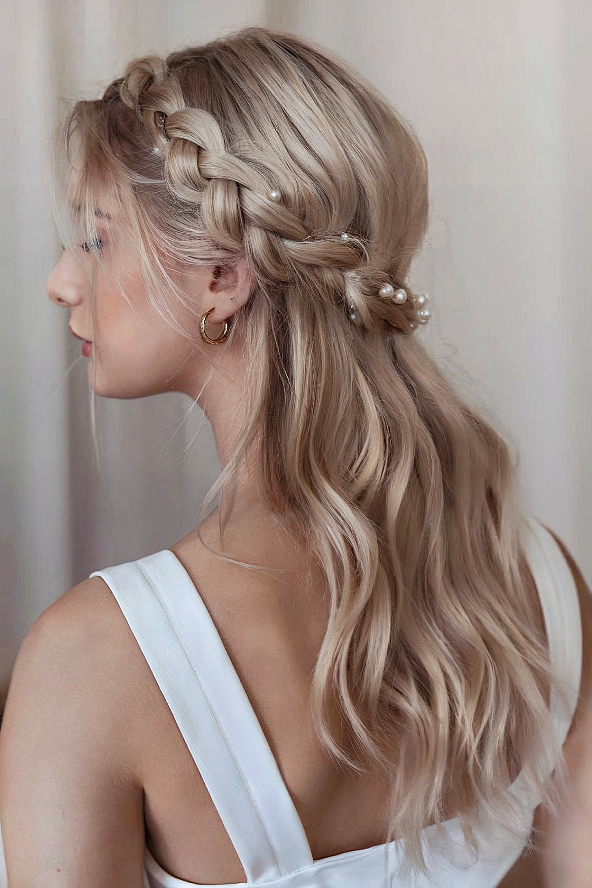 Half-up braided hairstyle with loose waves for homecoming