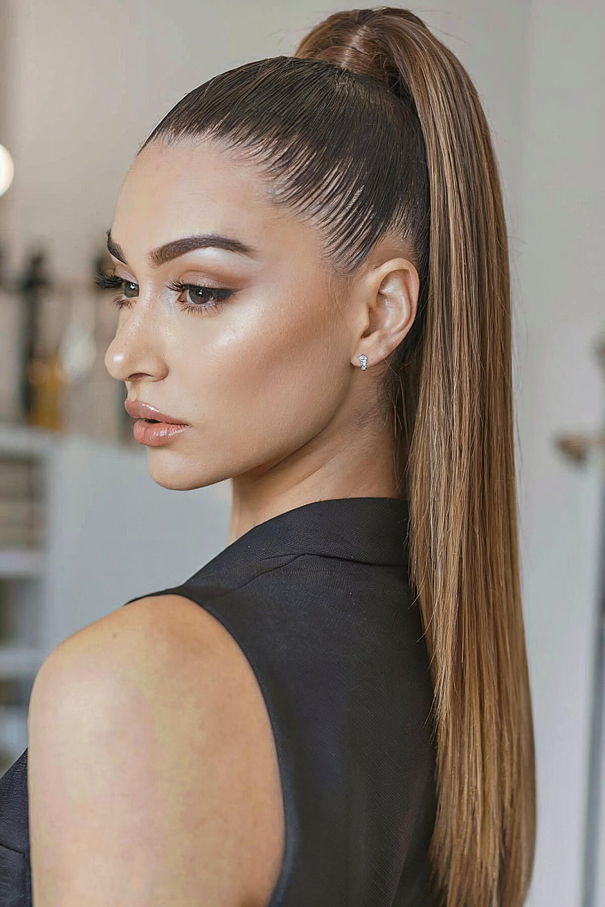 Sleek high ponytail with a wrapped base for thin hair at homecoming