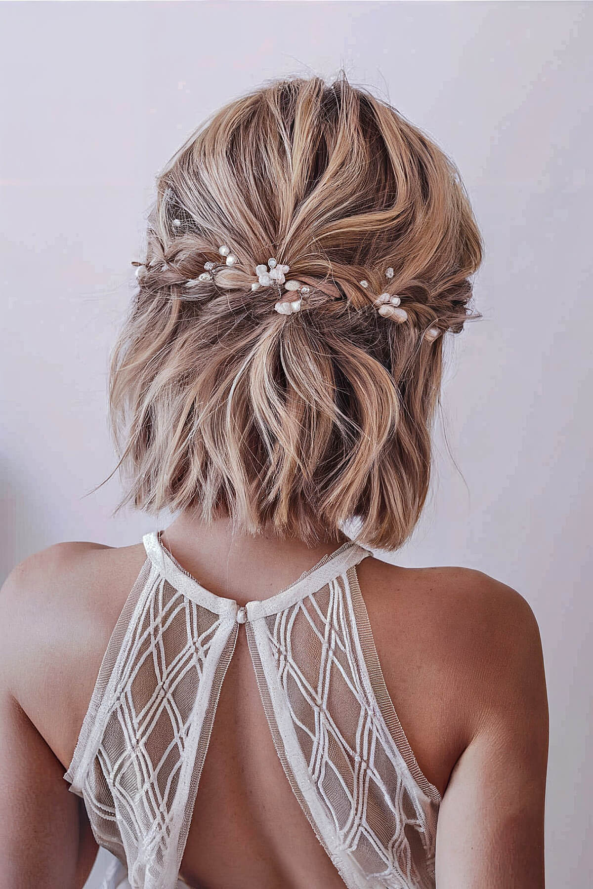 Short hair styled in a boho updo with pearl accents