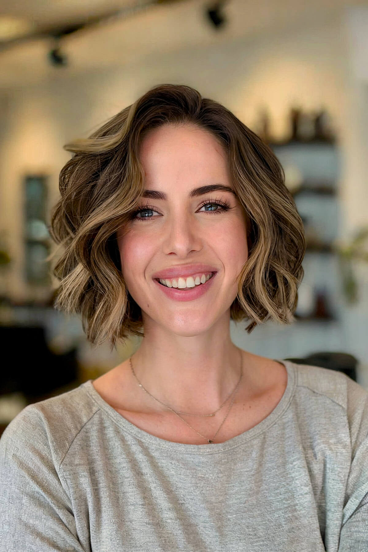 Neck-length textured bob with natural-looking loose curls and side part