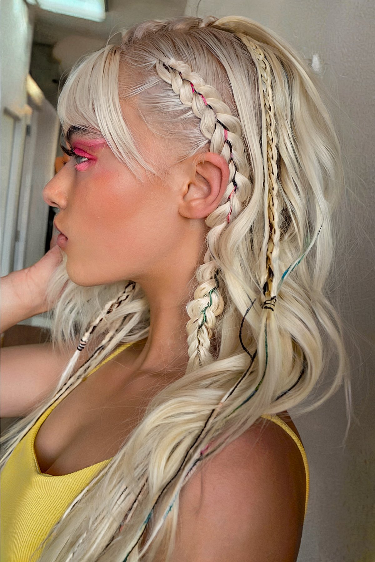 Blonde braids with pastel threads for a soft rave look