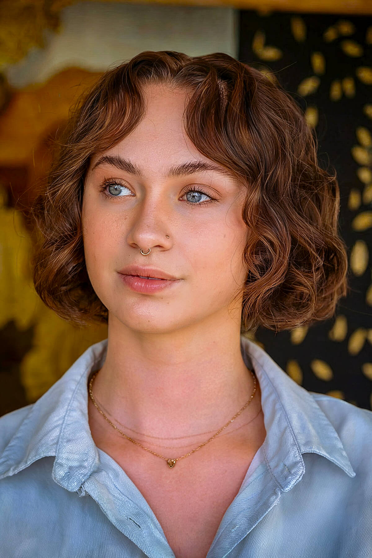 short curly haircut with curtain bangs