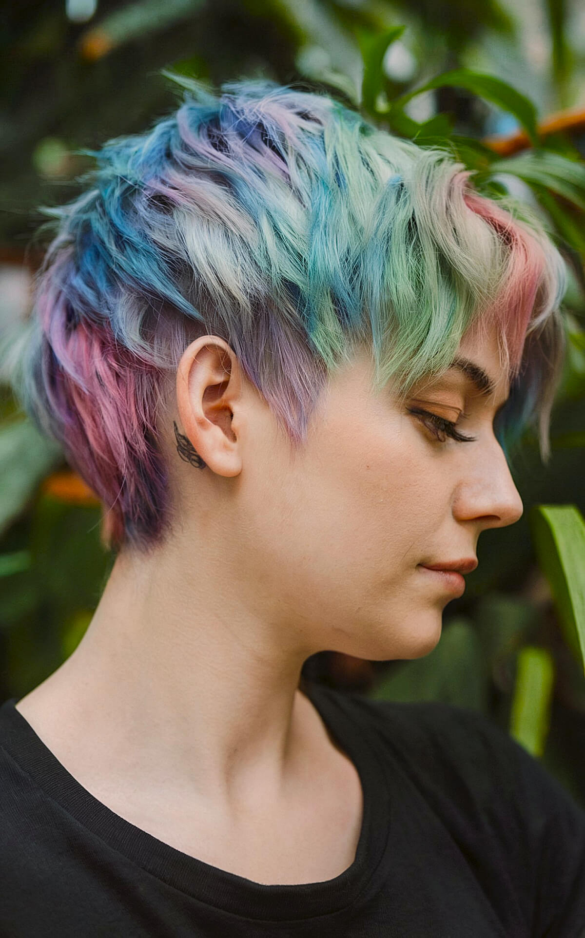 Vivid rainbow-colored pixie cut with choppy layers for short hair