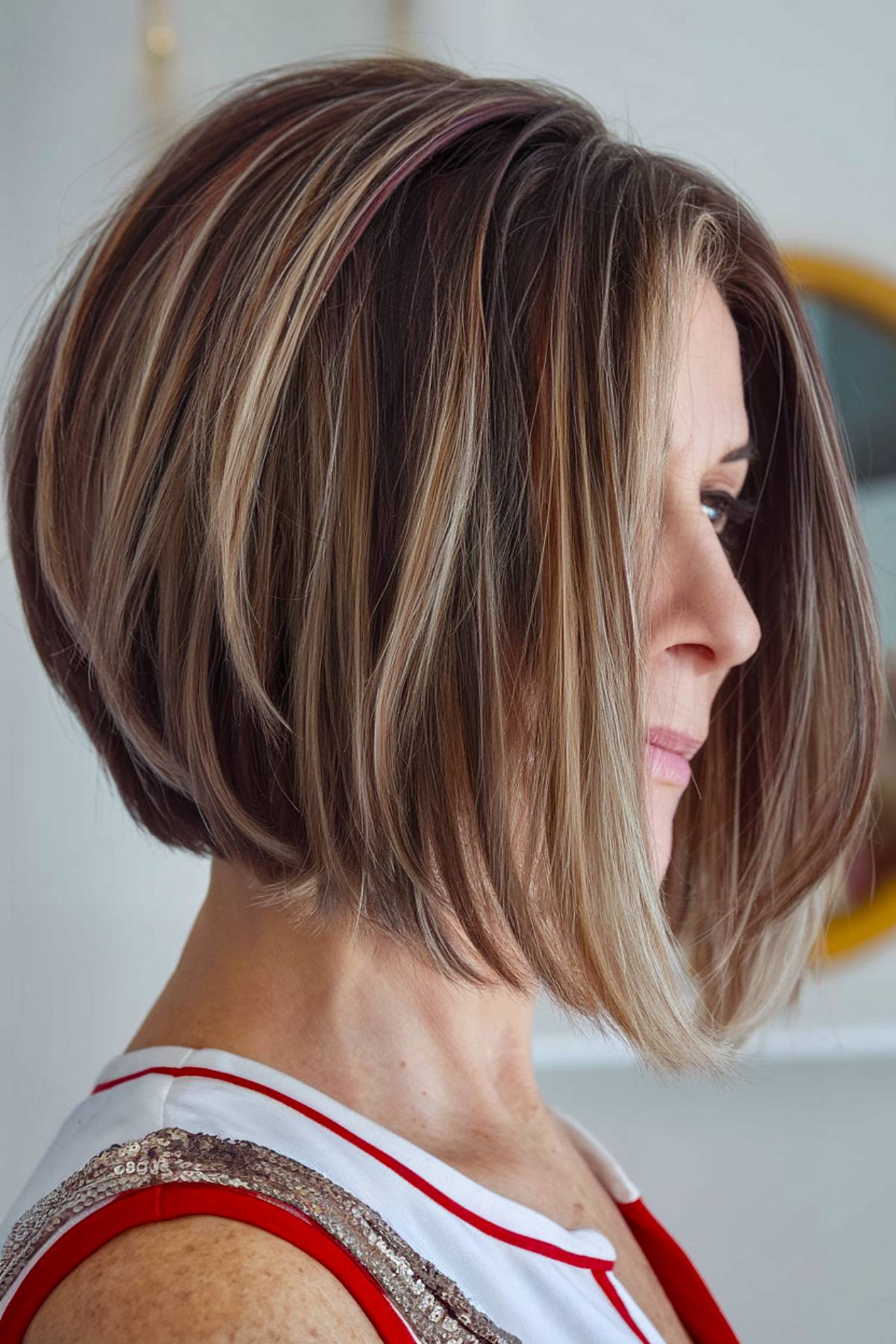 Angled bob with no bangs, featuring a clean and structured finish, ideal for older women seeking a low-maintenance cut