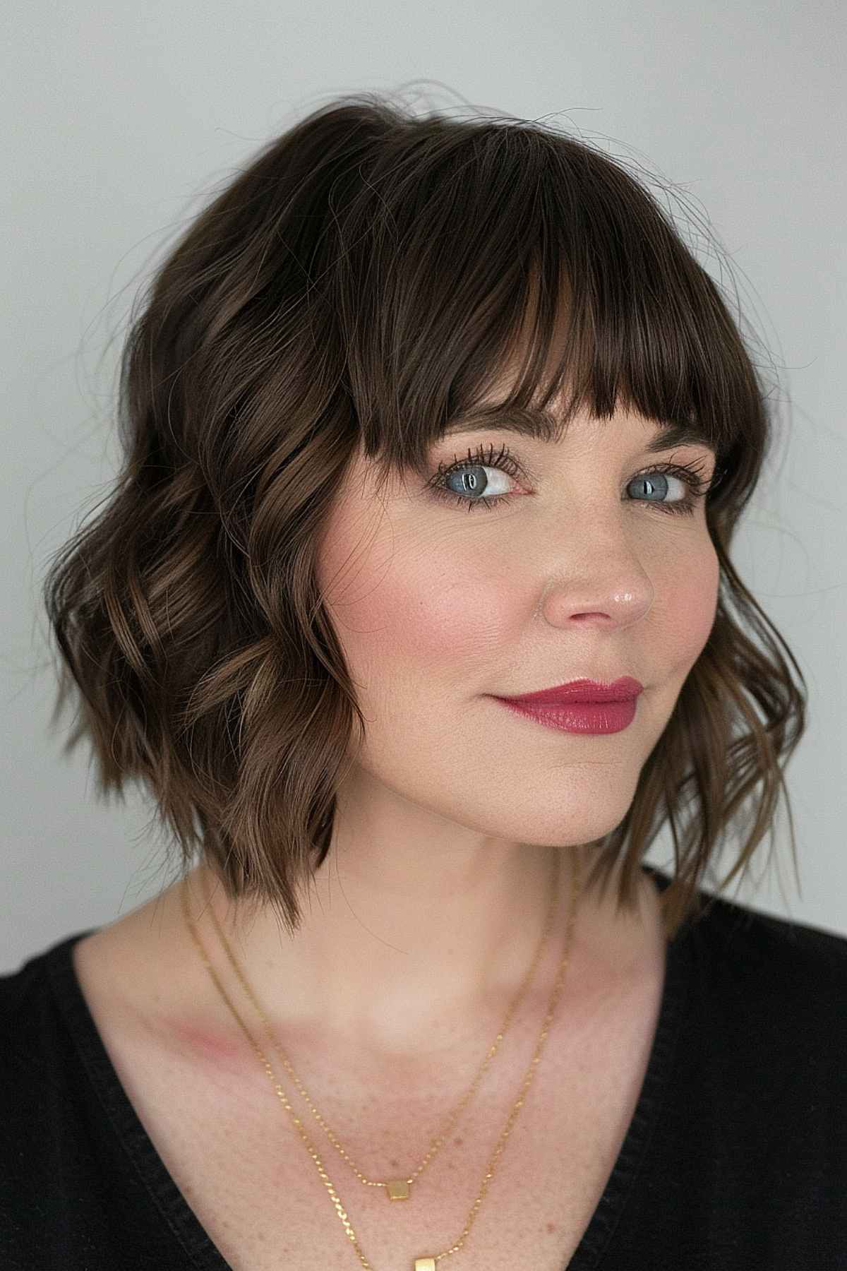 Angled bob with fringe on a woman with fine to medium hair.