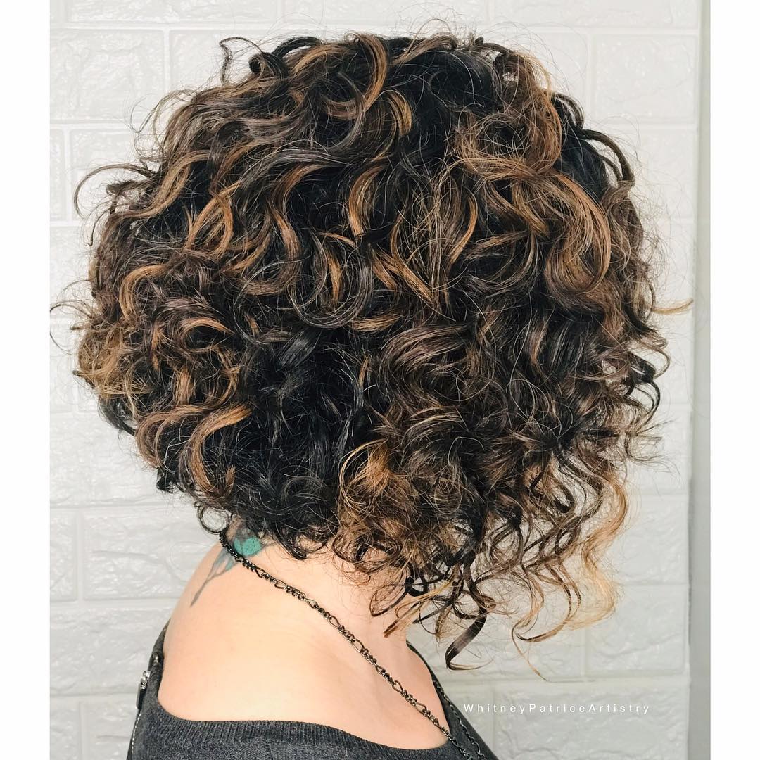 angled curly bob with pops of blonde