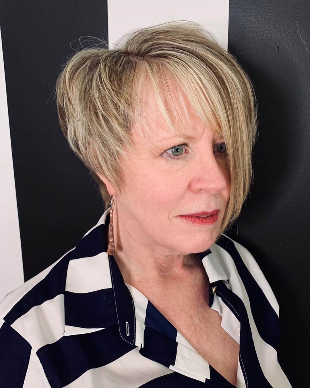 asymmetrical bob for ladies over 50 with grey hair