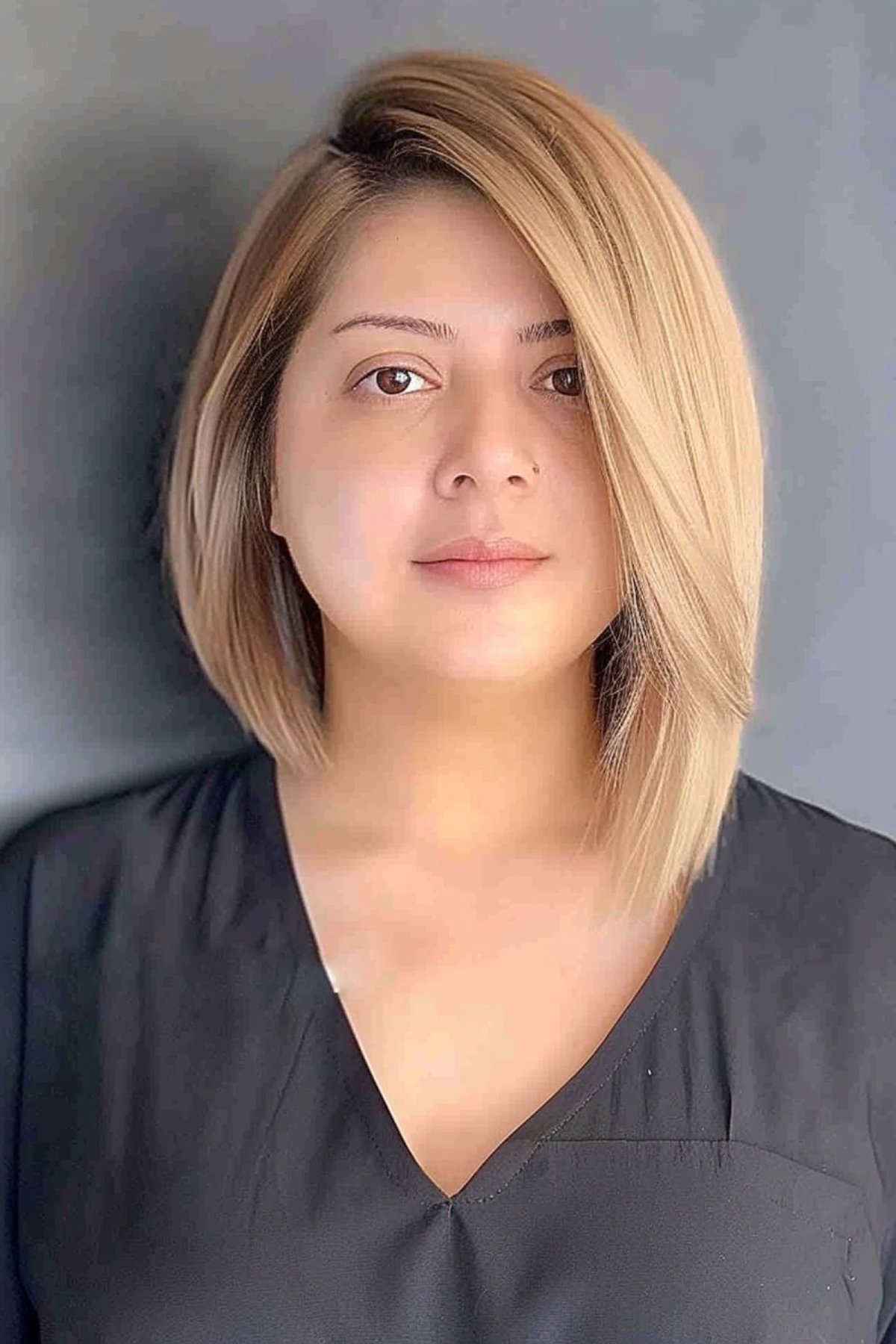 Asymmetrical long bob with deep side part to slim round faces
