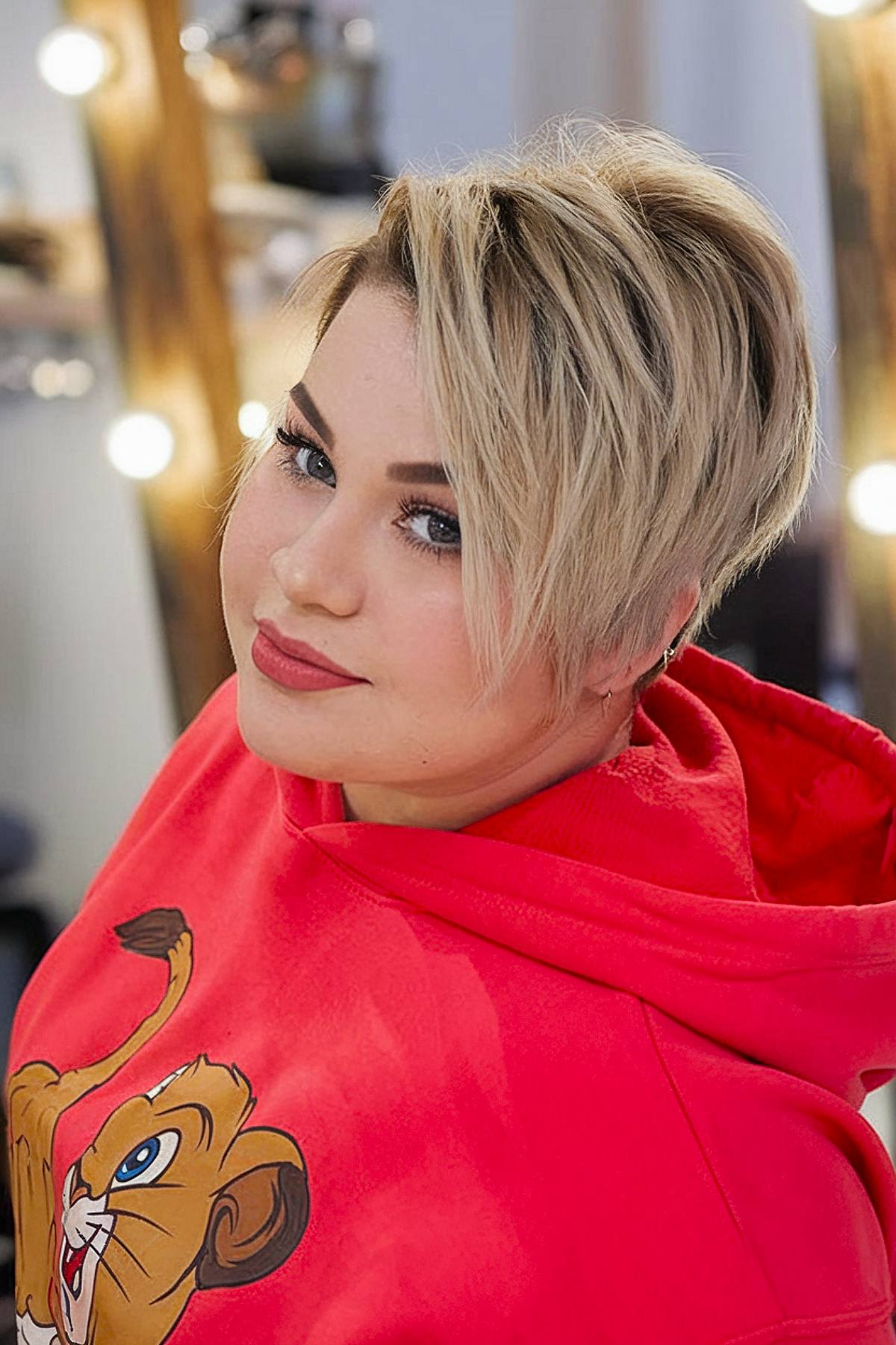 Asymmetrical pixie cut for plus size women with face-framing layers