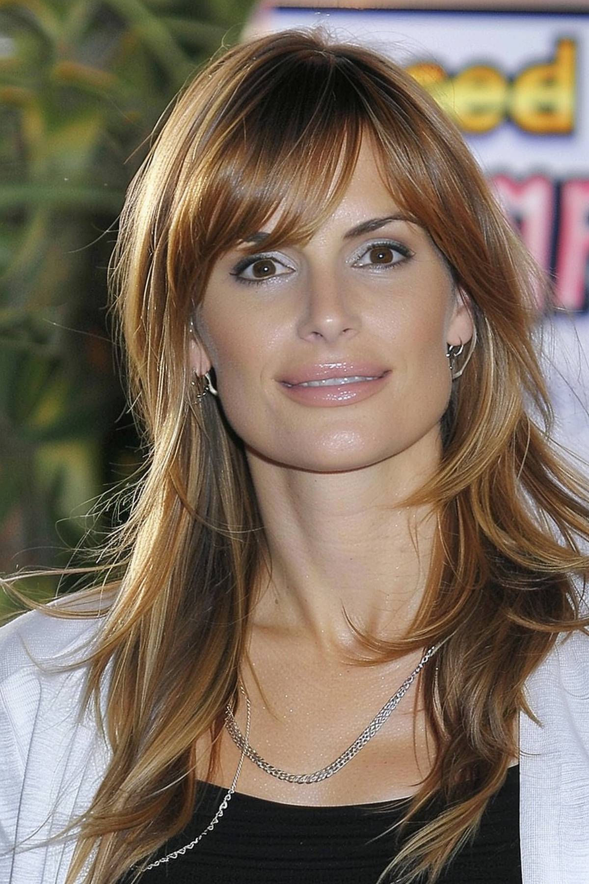 Side-swept bangs are styled to accentuate your long face shape, giving you a sophisticated and chic look.