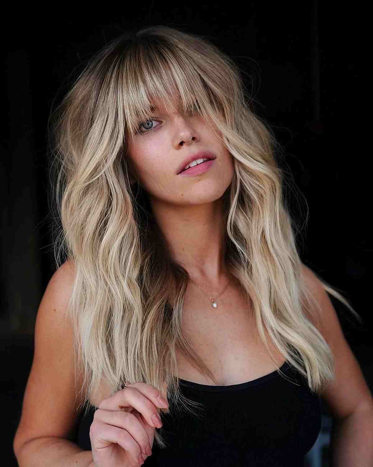 Beach Wavy Blonde Hair with Straight Bangs for a Long Face