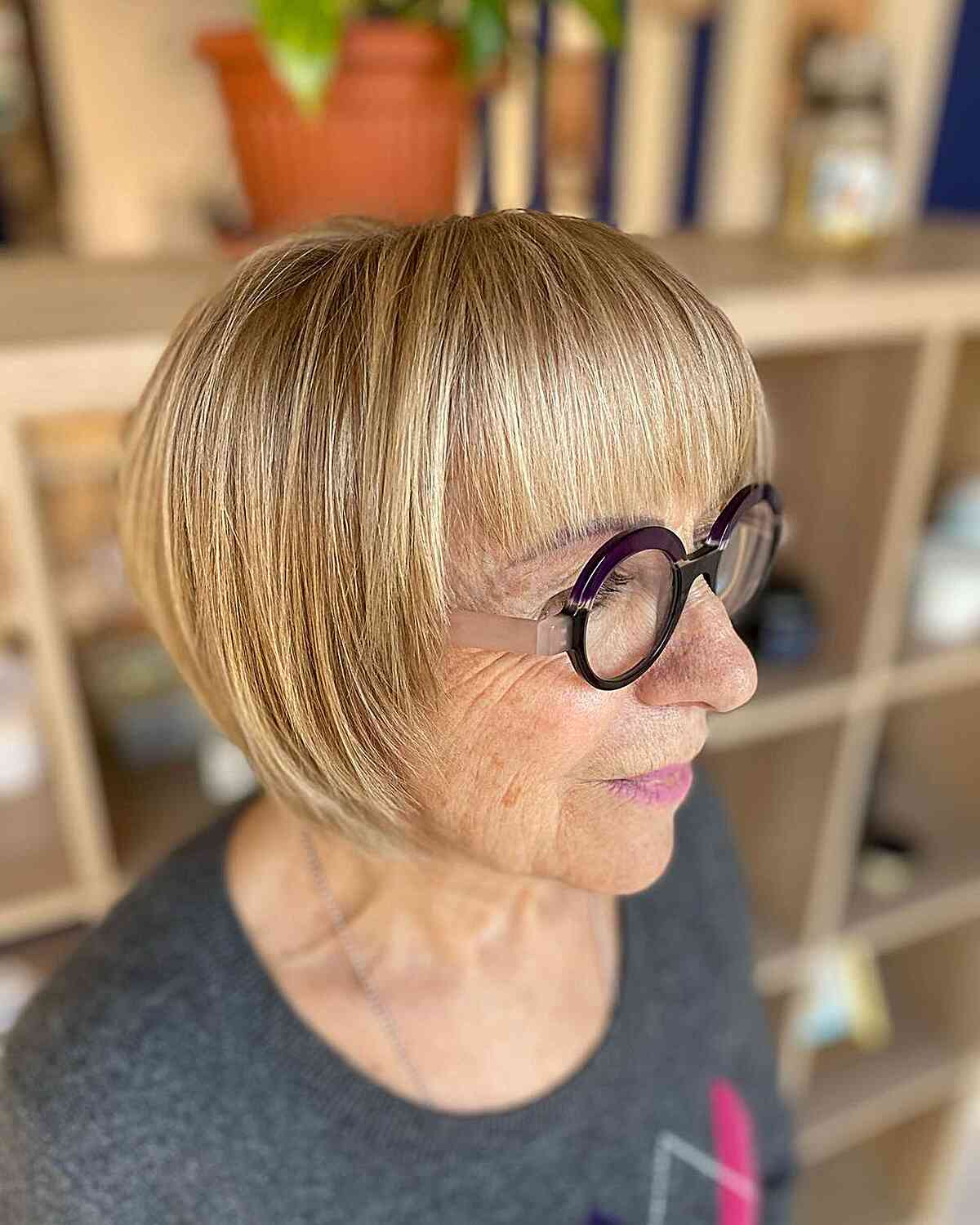 Beautiful Golden Highlights on a Short Bob for 60-Year-Olds with Glasses
