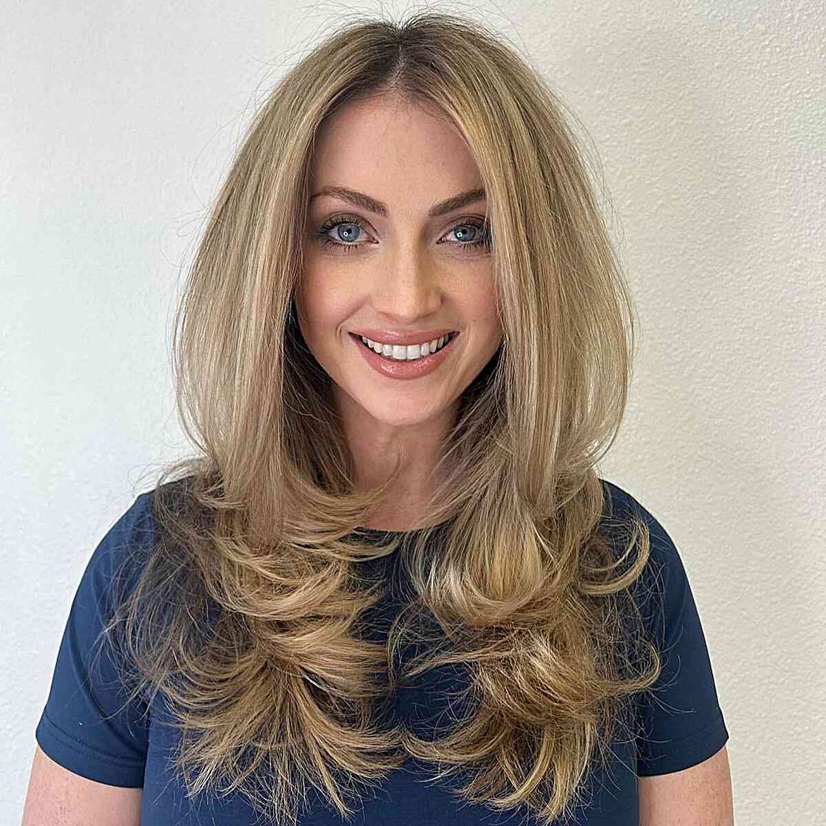 Octopus Cut Long Blonde Hair with a Center Part Long Blonde Hair with a Center Part and lots of layering at the ends for an oval face