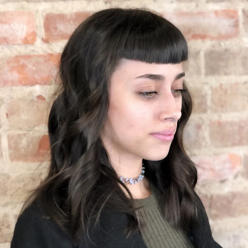 A trendy bronde colored shag with bangs