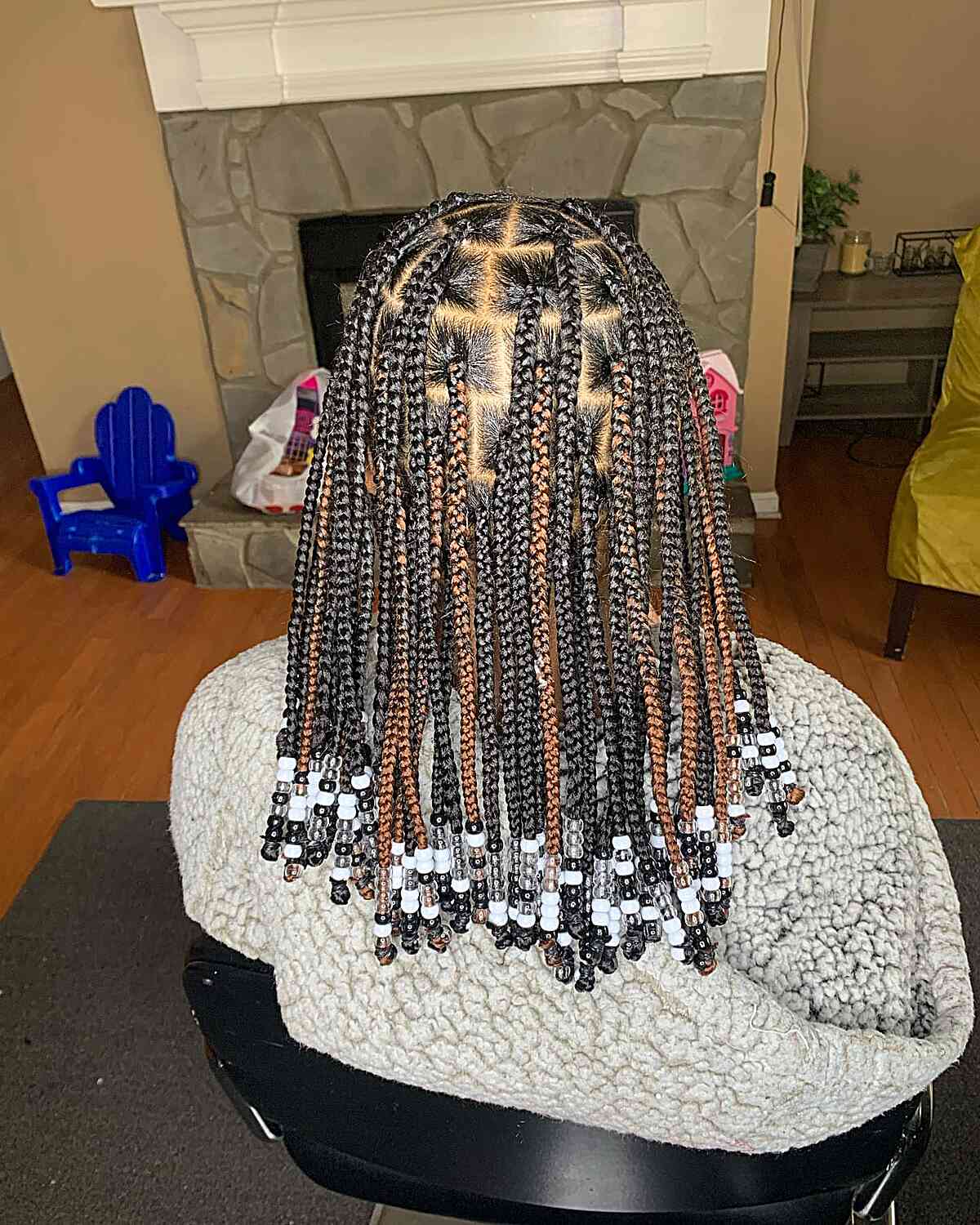 Mid-Length Black Knotless Braids with Brown Highlights and Black-White Beads