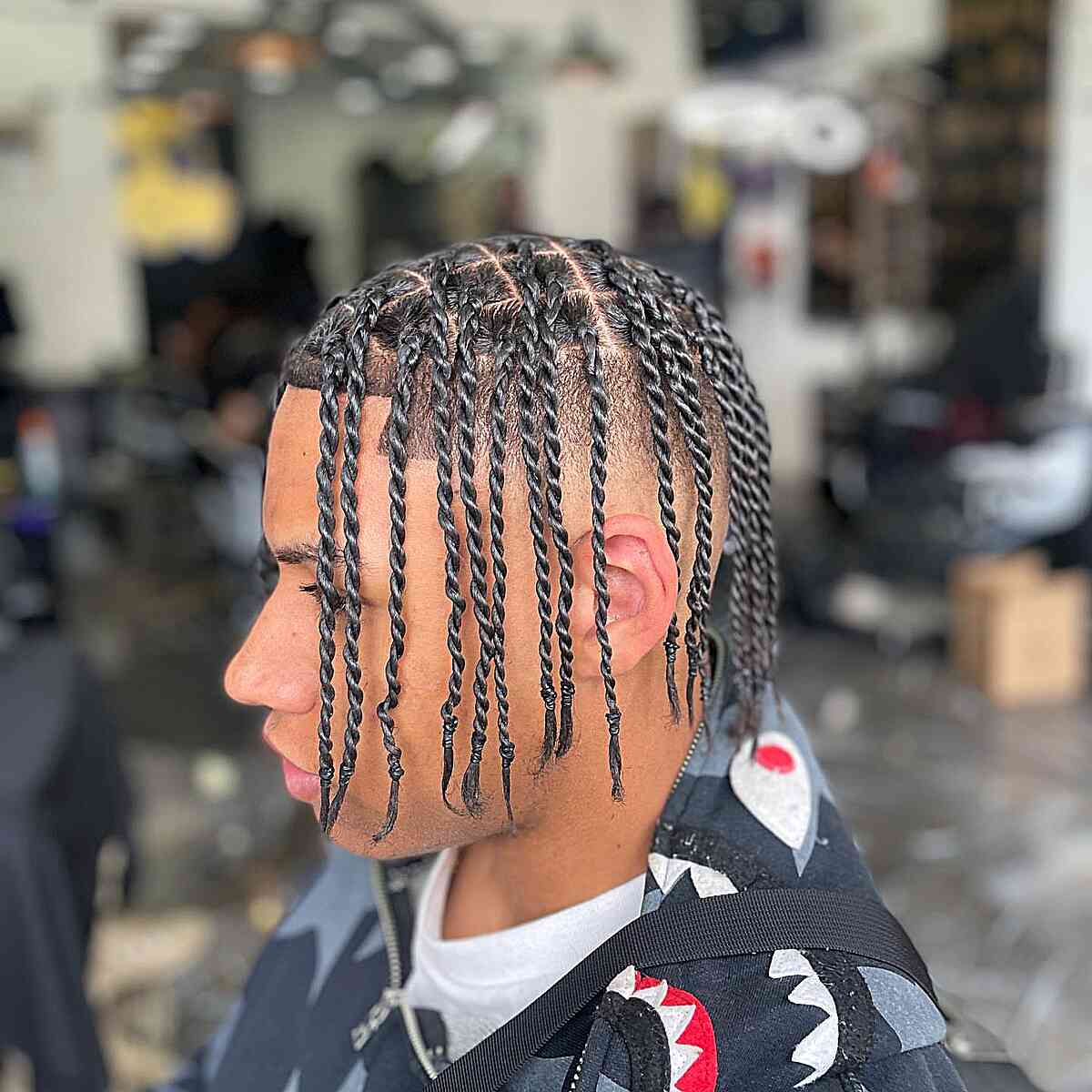 A picture of a black men with medium length dreads and a disconnected undercut