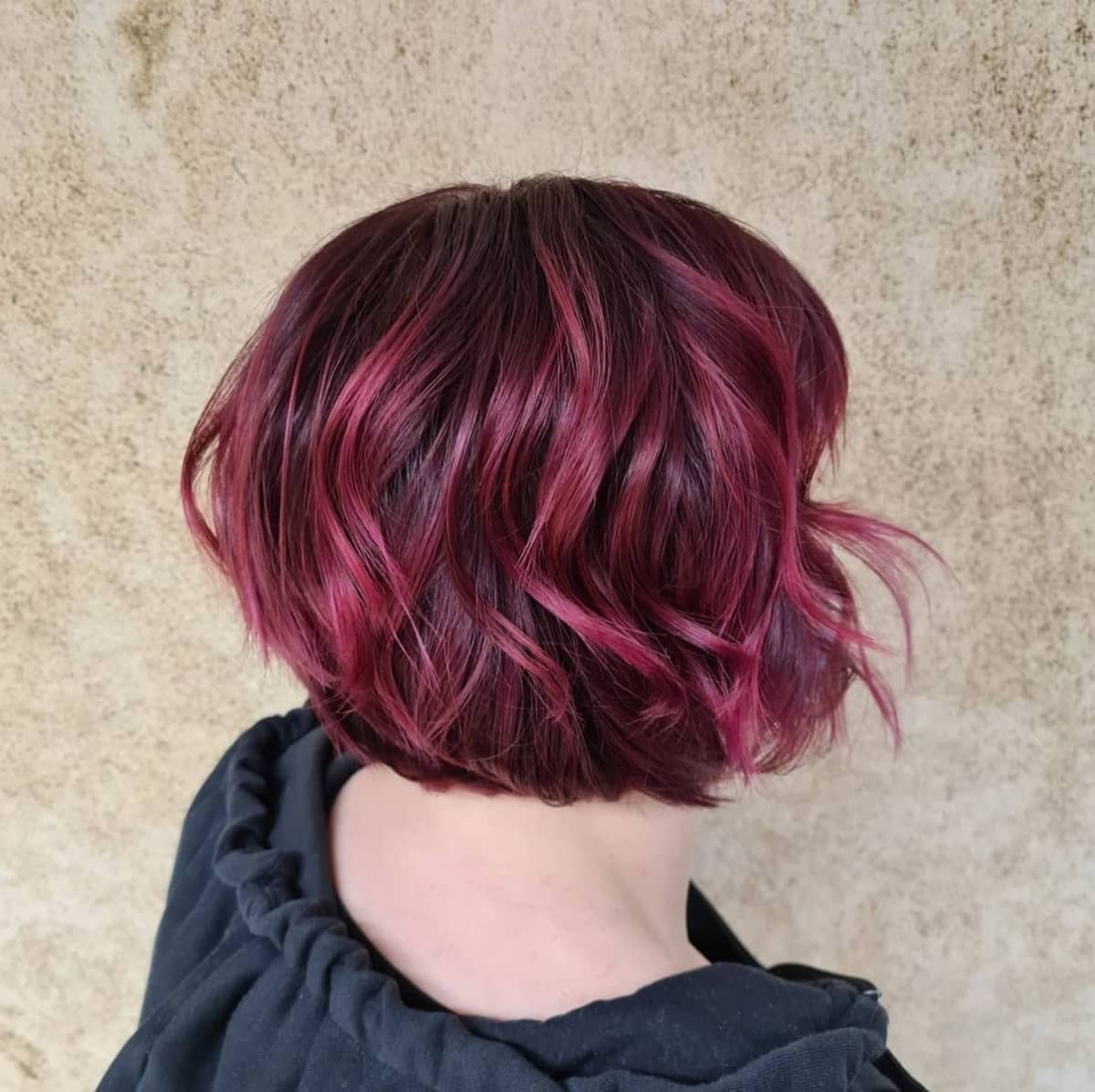 Black shag bob hairstyle with pink highlights