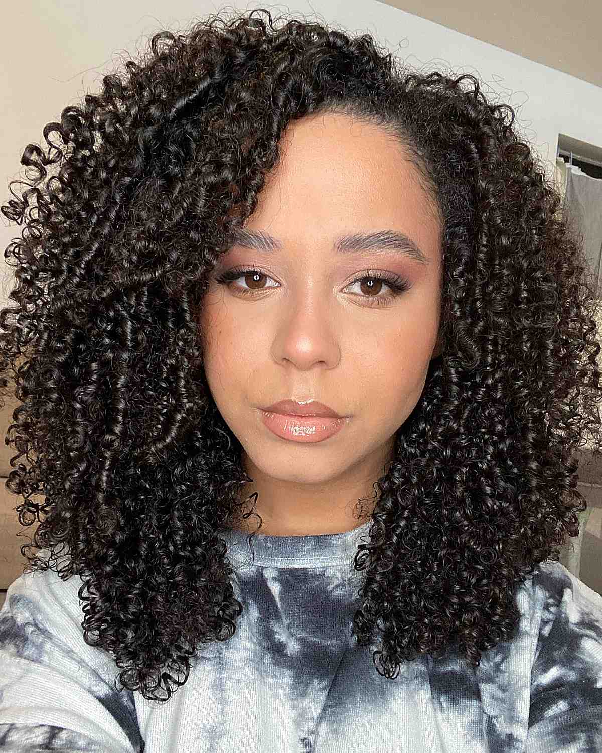 black woman with medium-length hair and tight ringlets