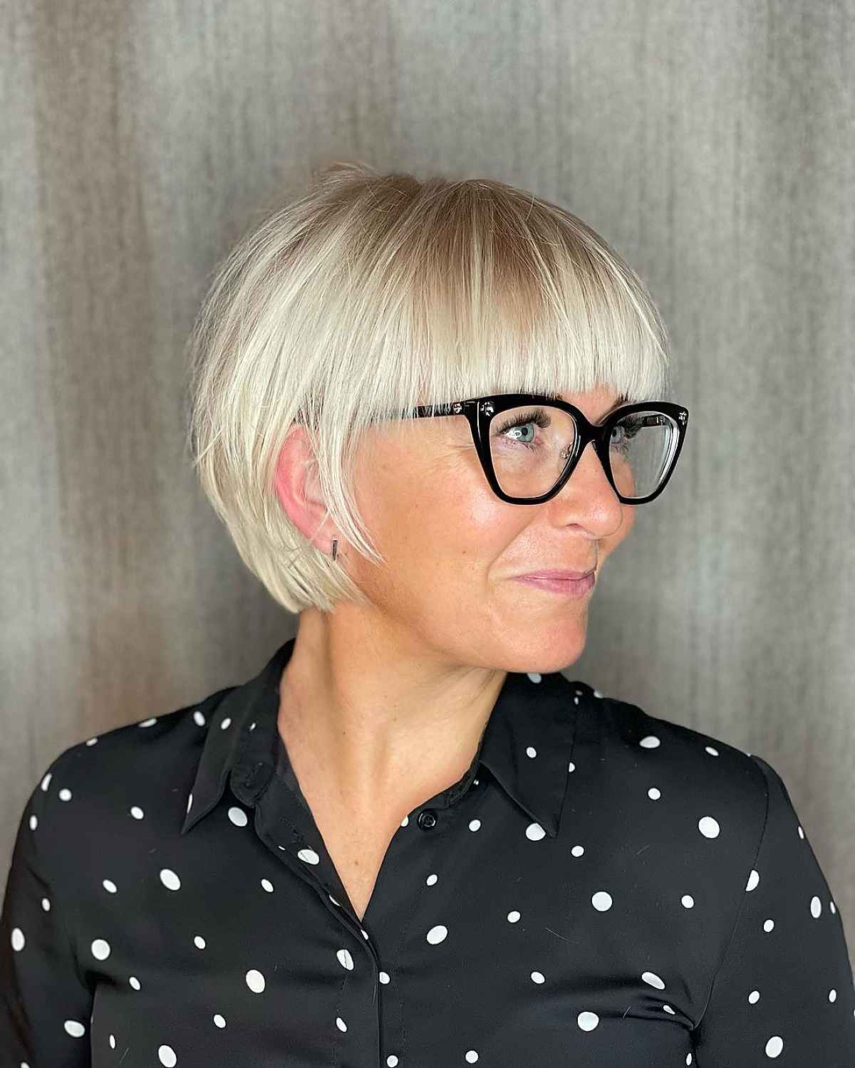 chic blonde bob with straight bangs