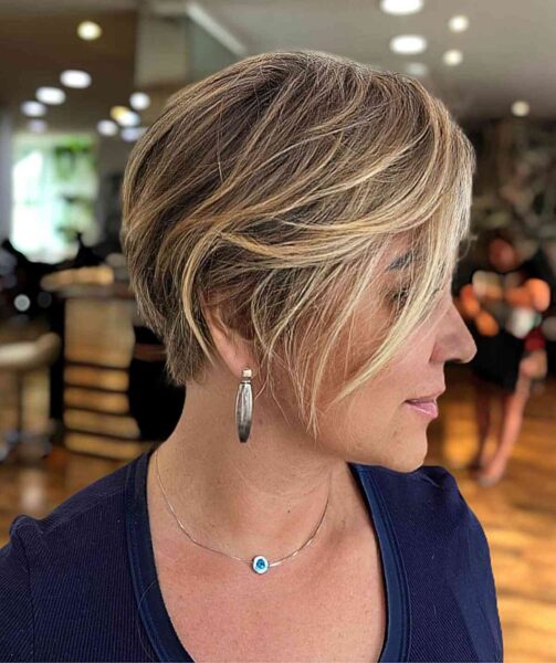 A Blonde Layered Pixie With Long Bangs for Thick Hair