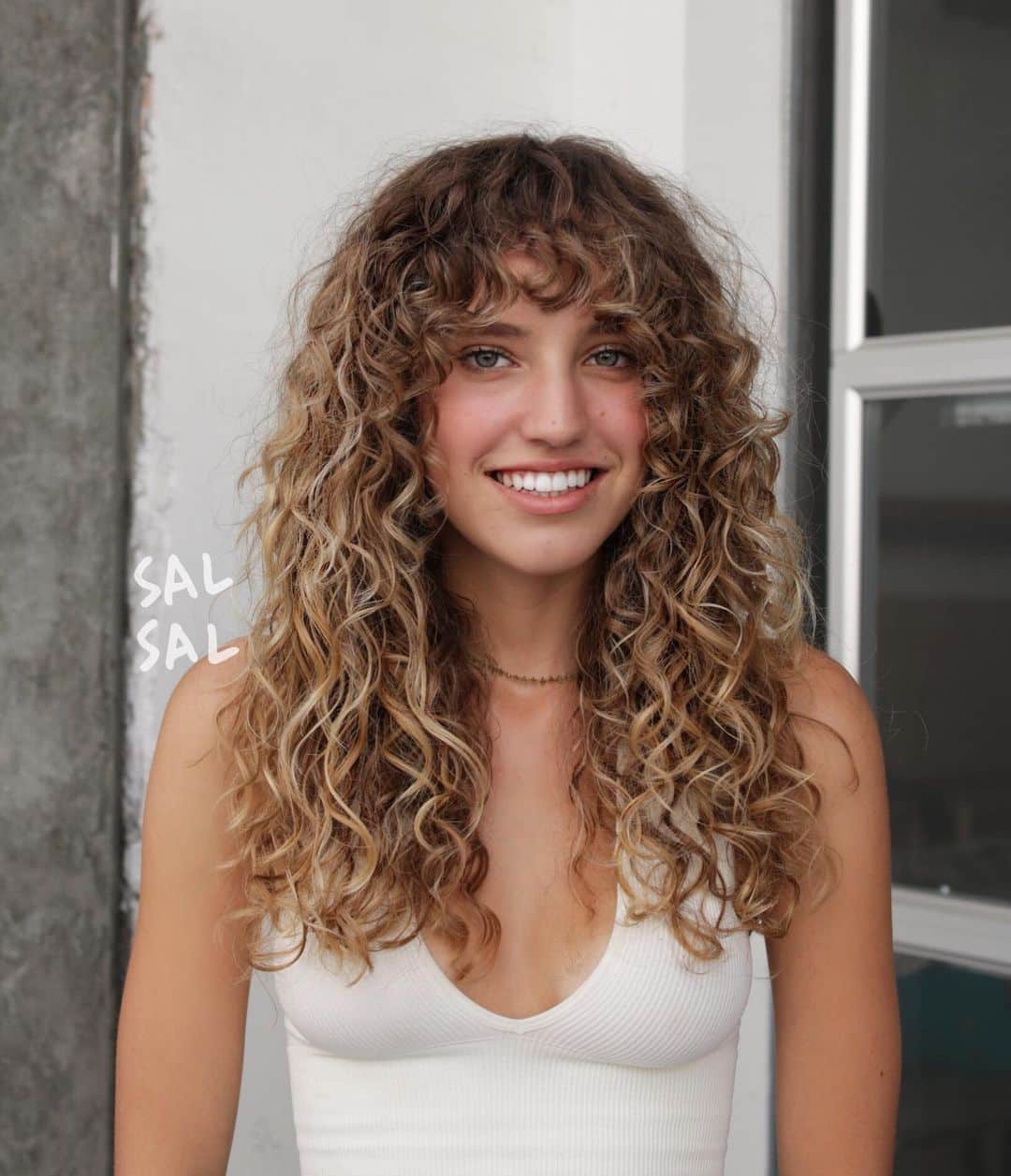 long curly hair with a side part