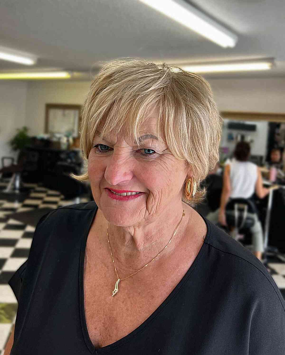 Ear-Length Shaggy Blonde Pixie with Choppy Bangs and Flipped Ends for Older Women