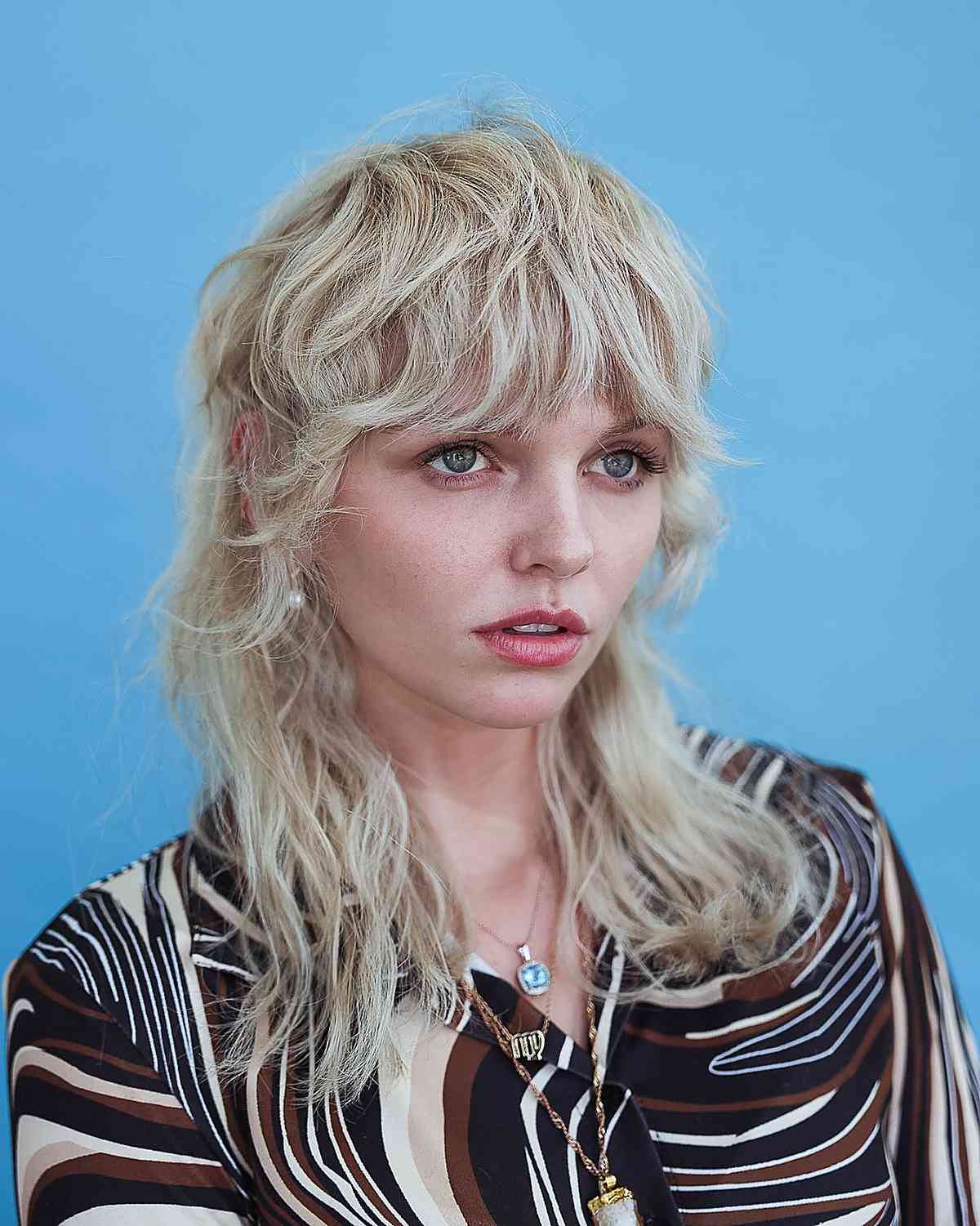 blonde shaggy mullet with bangs
