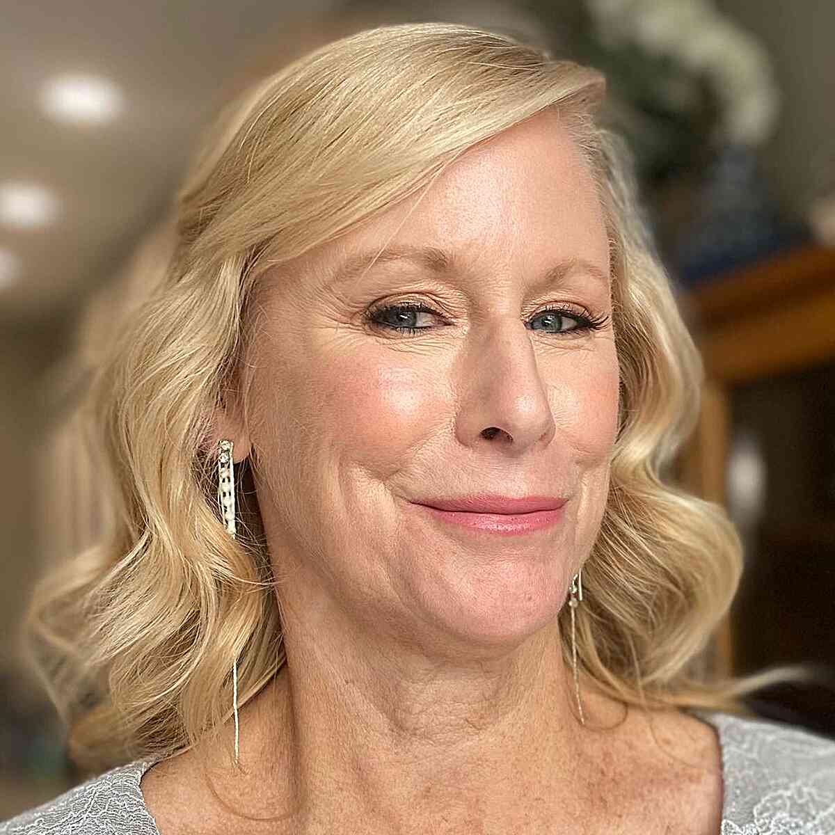 Blonde Waves with Sweeping Bangs and a Deep Side Part for women over 60 