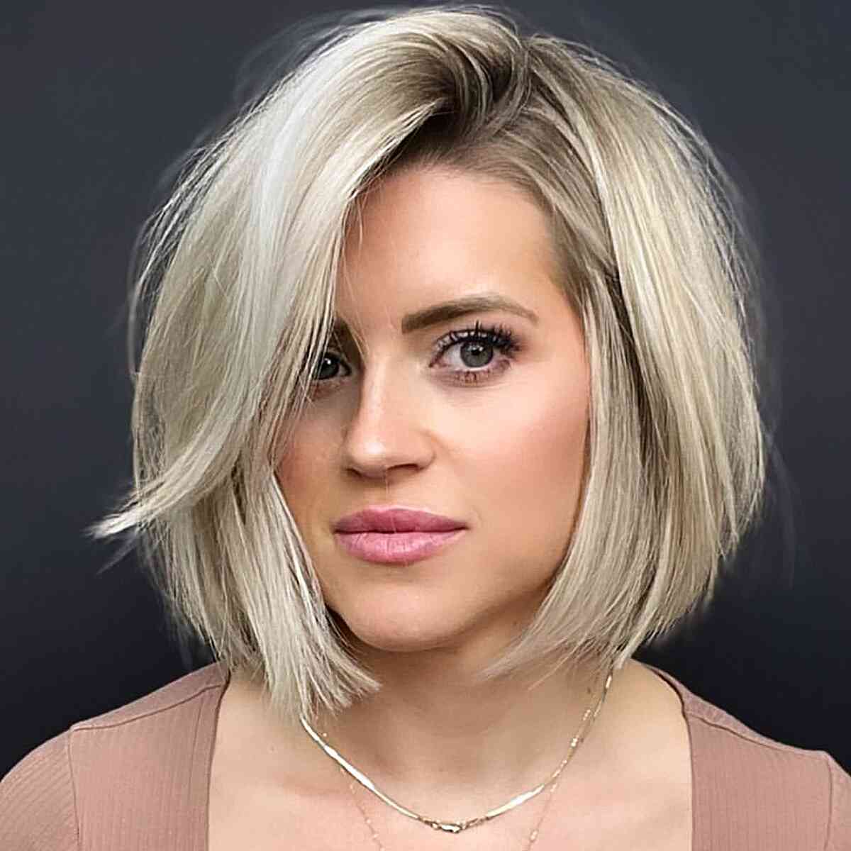 Blunt and Side Parted Reversible Bob Cut for women with soft blonde hair