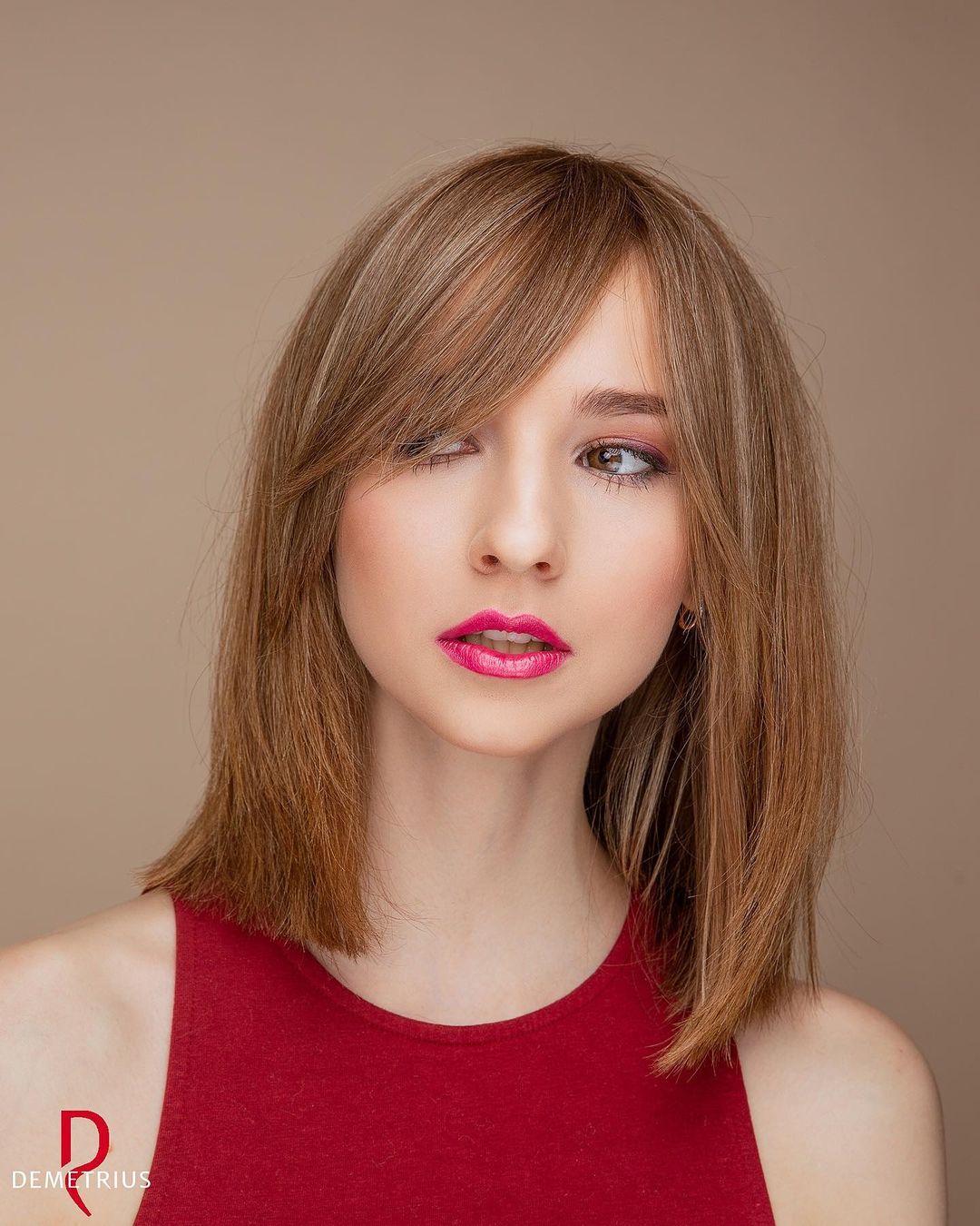 blunt long bob with a deep side part and angled bangs