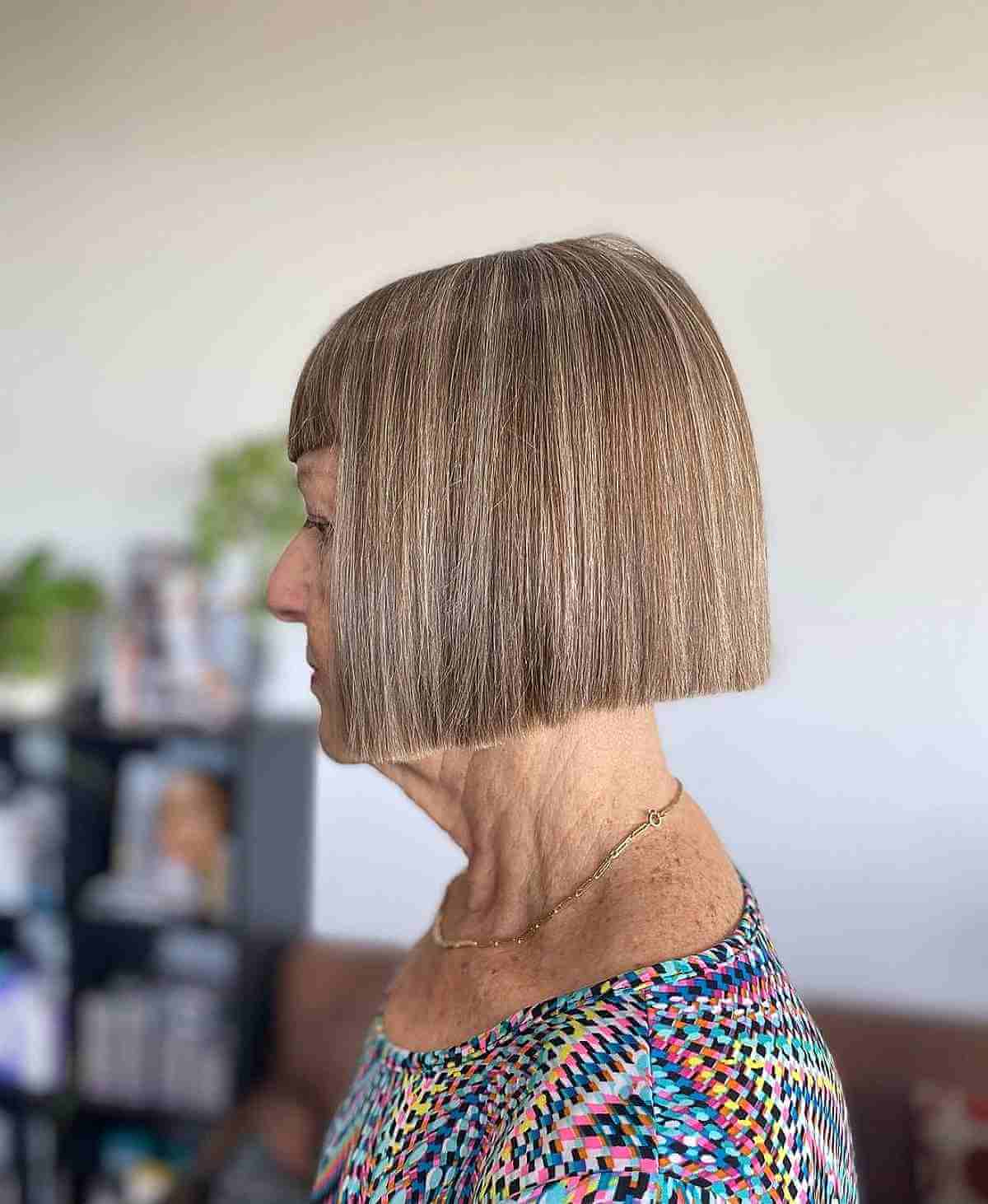Blunt Short Haircut with Bangs for a 70-Year-Old Lady