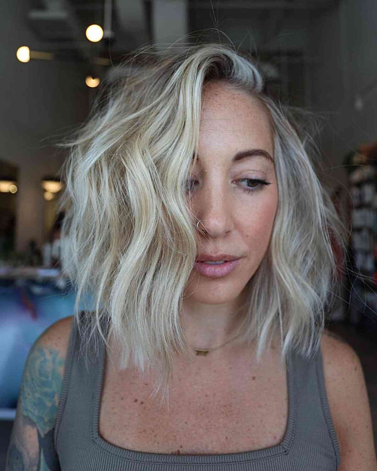 Bob Cut with Short Blonde Waves with Deep Side Part and Shattered Layers
