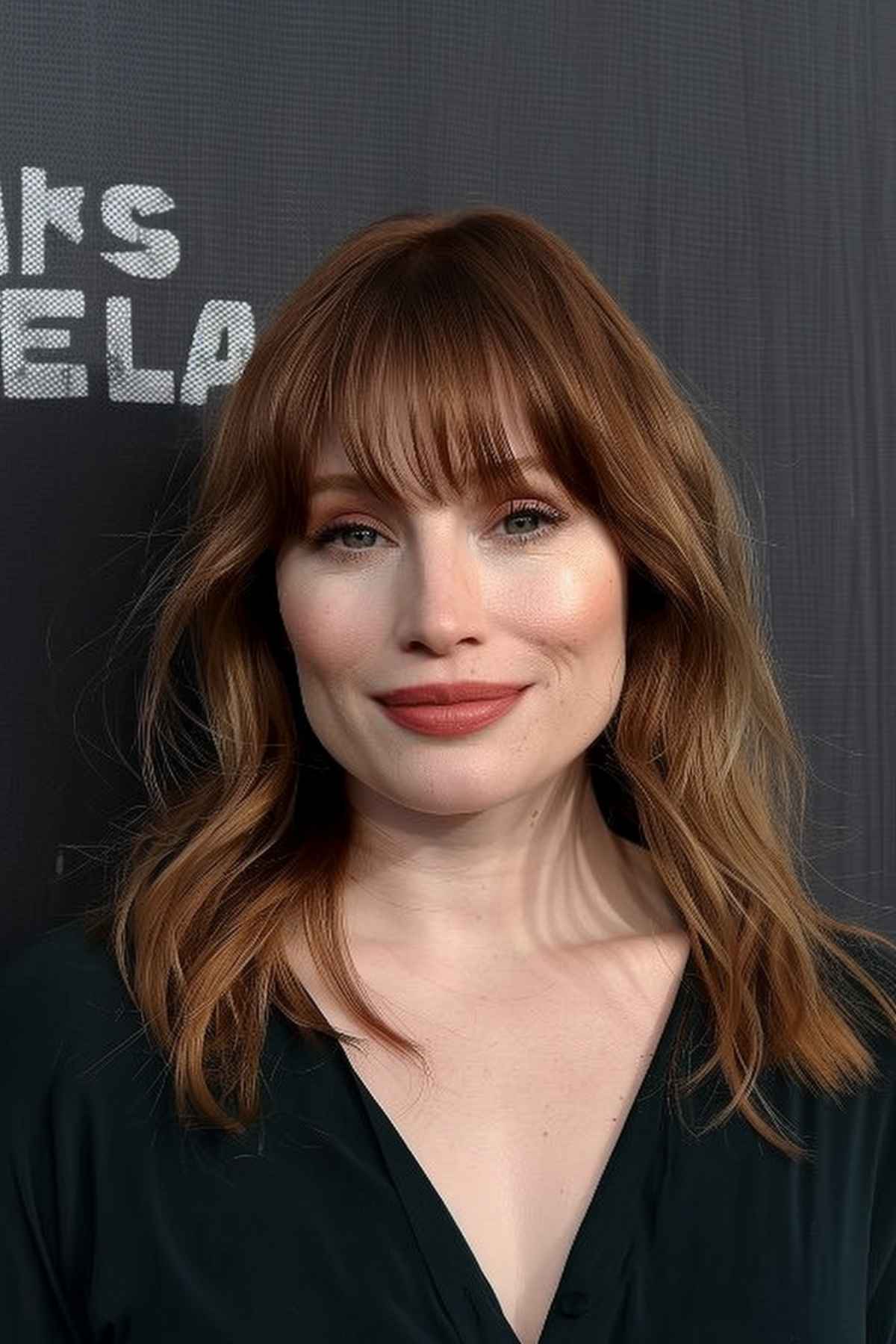 Woman with long bob, bangs, and layers for thick hair. 