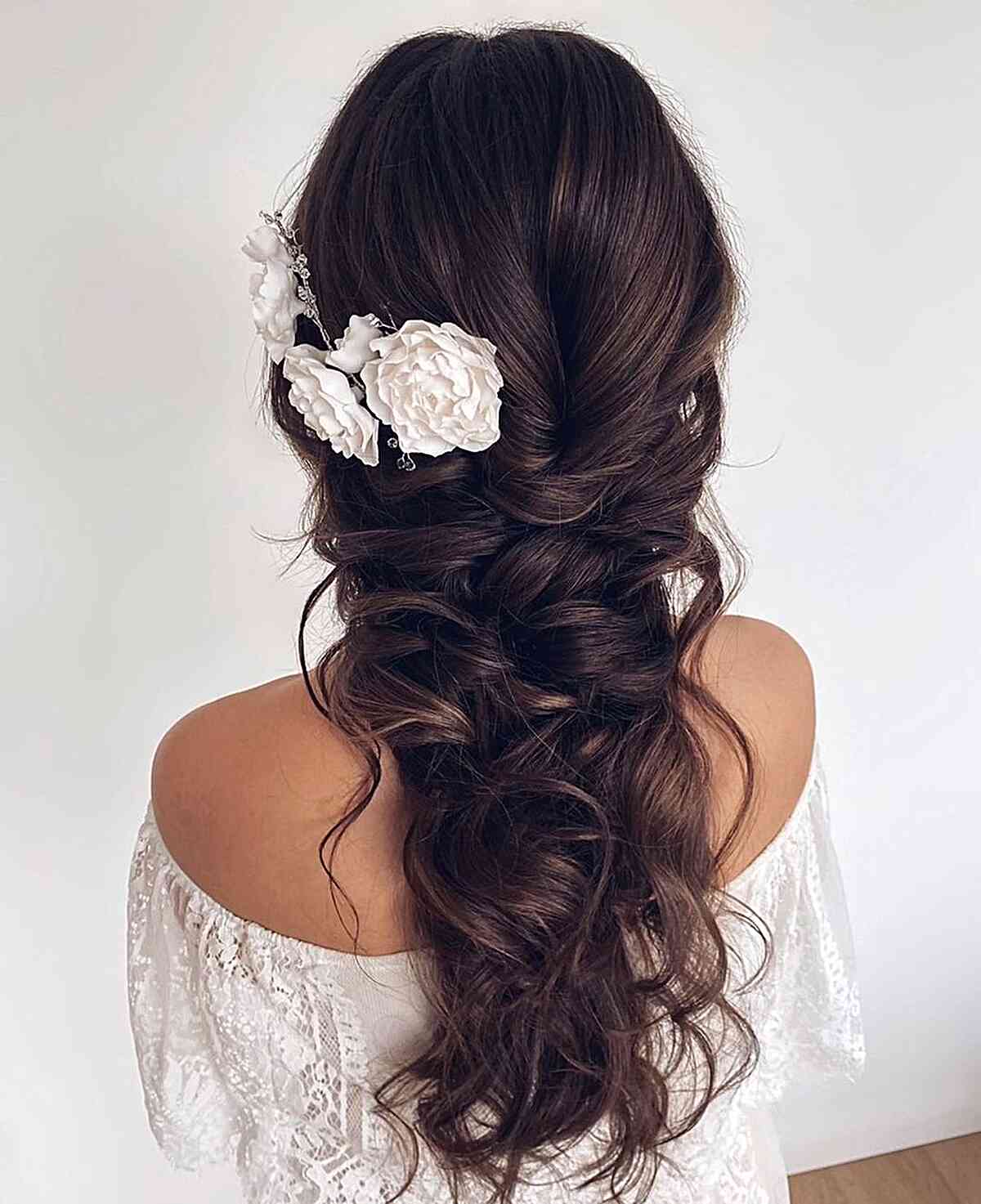 Bohemian-Inspired Dark Long Braided Hairdo for a Bridesmaid with flower accessories