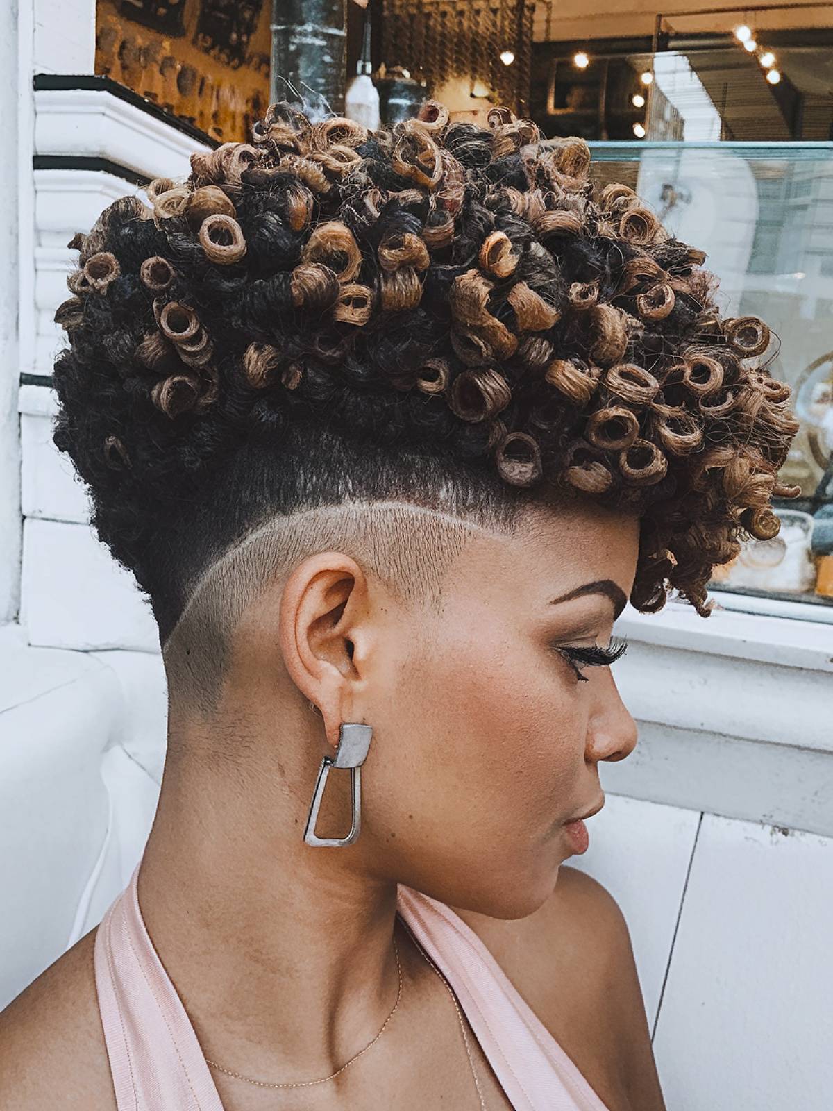 Afro hair with tight curls and shaved undercut sides