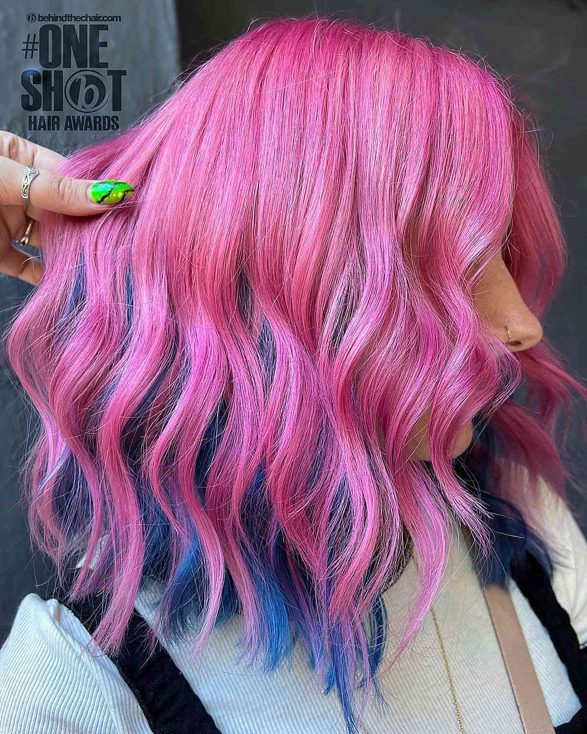 Bold Pink Hair with Blue Peekaboo Highlights Underneath