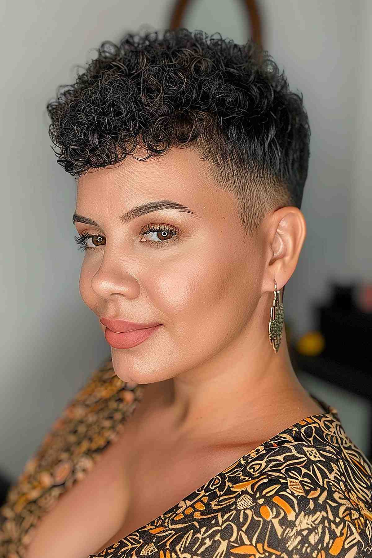 Bold long pixie cut with textured top layers for coily hair