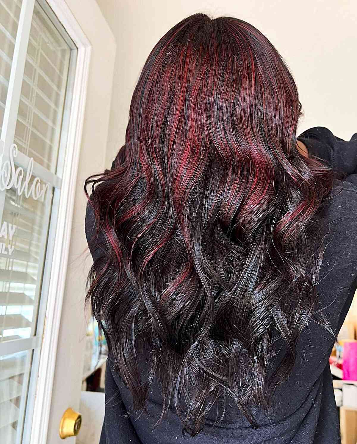 Bold Red Partial Highlights on Long Wavy Dark Hair