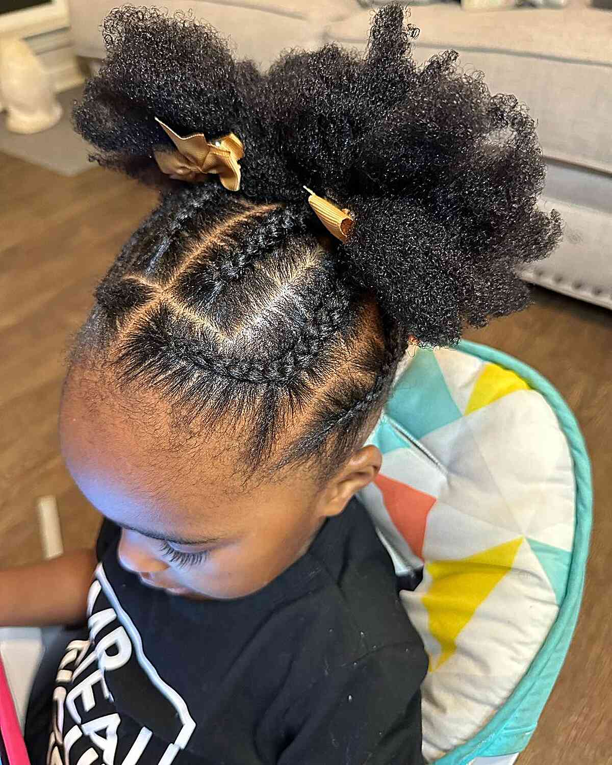 Cute Braided Updo with Double Afro Puffs and Golden Bows for Black Girls