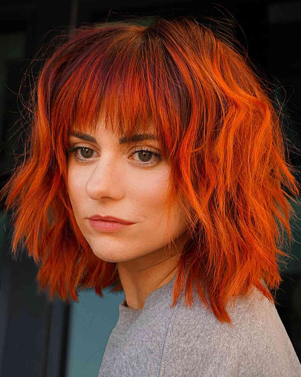 Bright and Fiery Copper-Toned Choppy Bob with Bangs