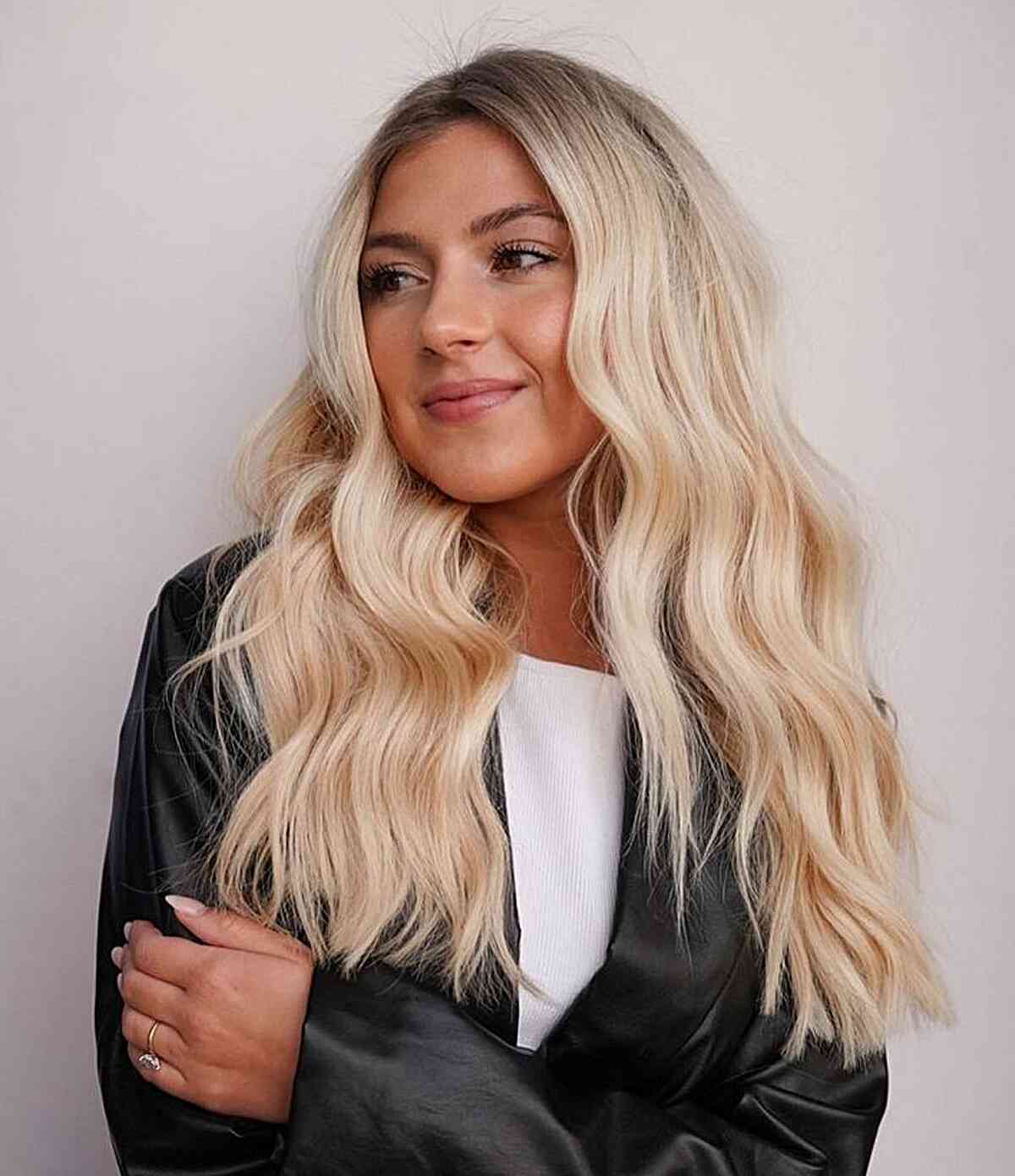 Bright Blonde Ombre with Dark Roots and a Lived-In Wavy Texture