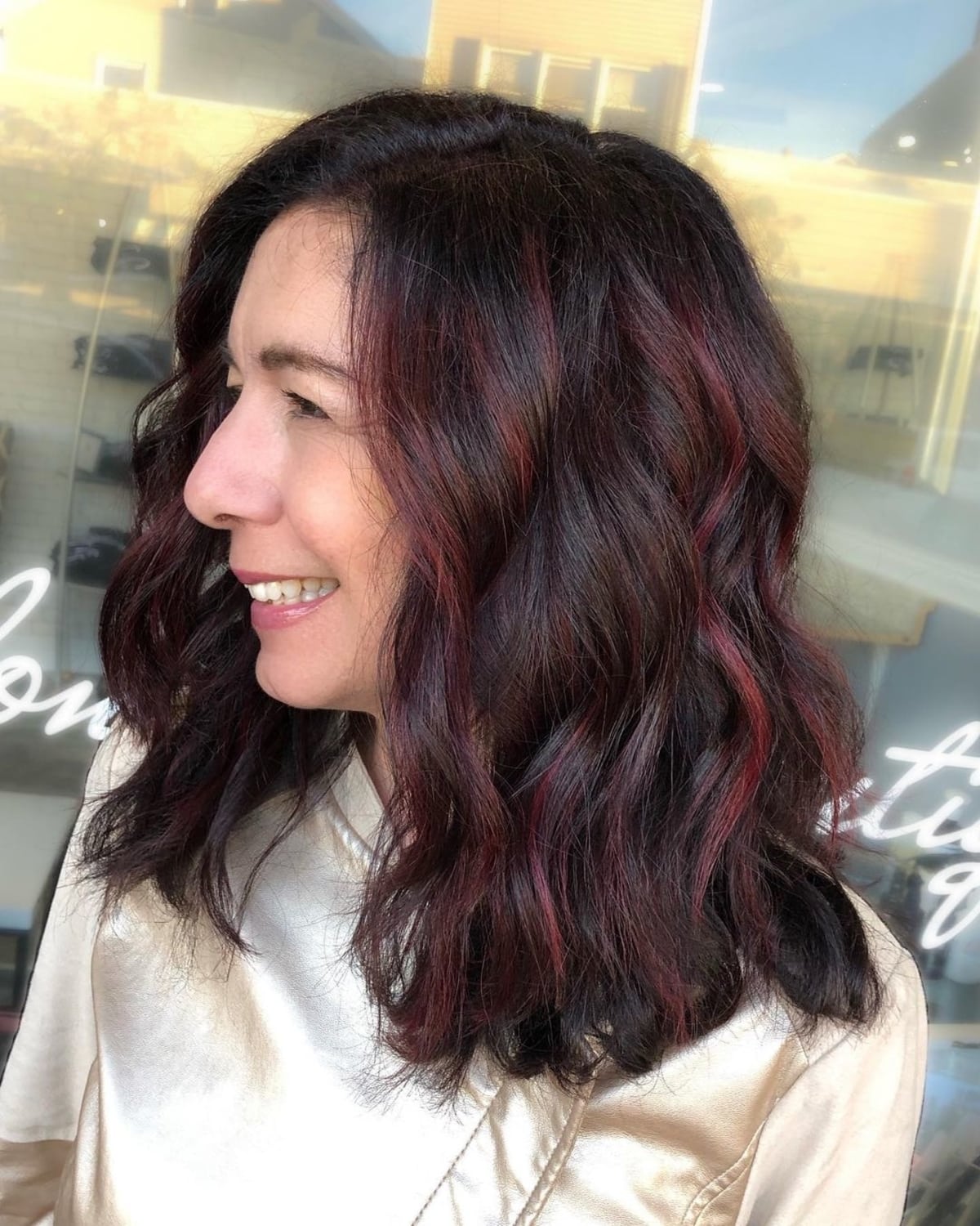 Bright burgundy highlights on very dark hair