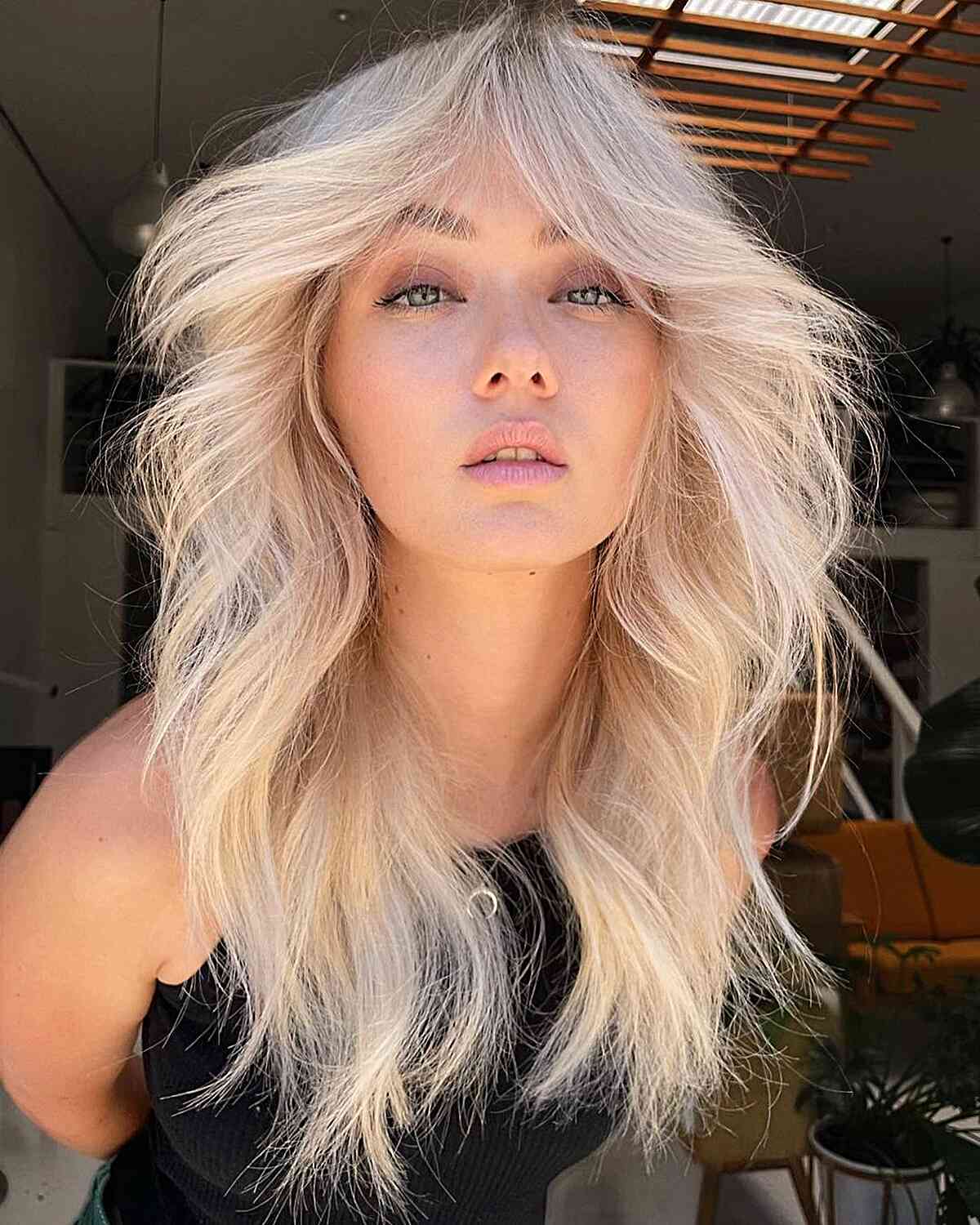 Bright Creamy Blonde Blowout with Long Curtain Bangs and Layers