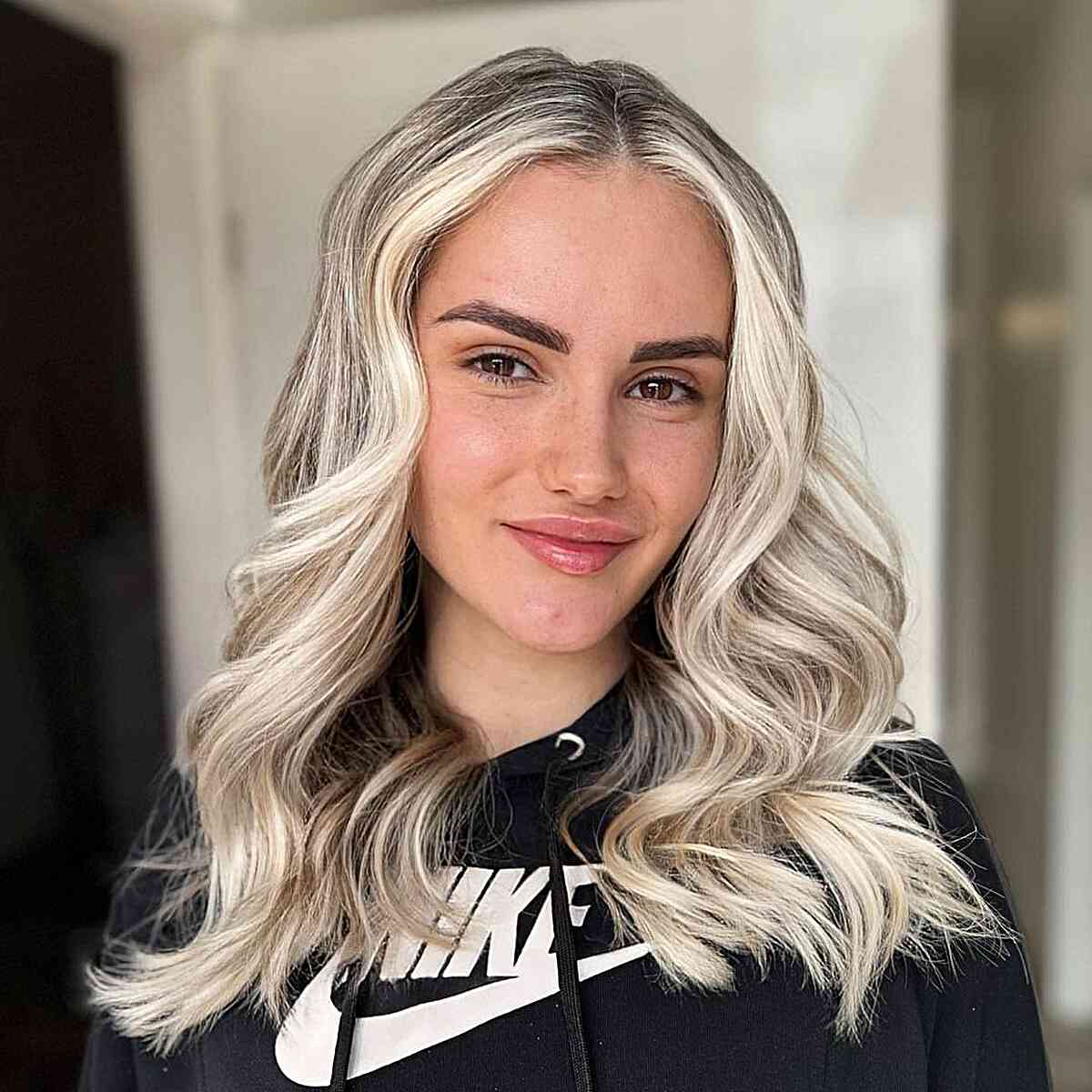 Bright Platinum Medium-Length Hairstyle with a Middle Part