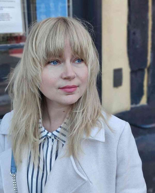 A Brow Skimming Bangs for Round Face Shapes
